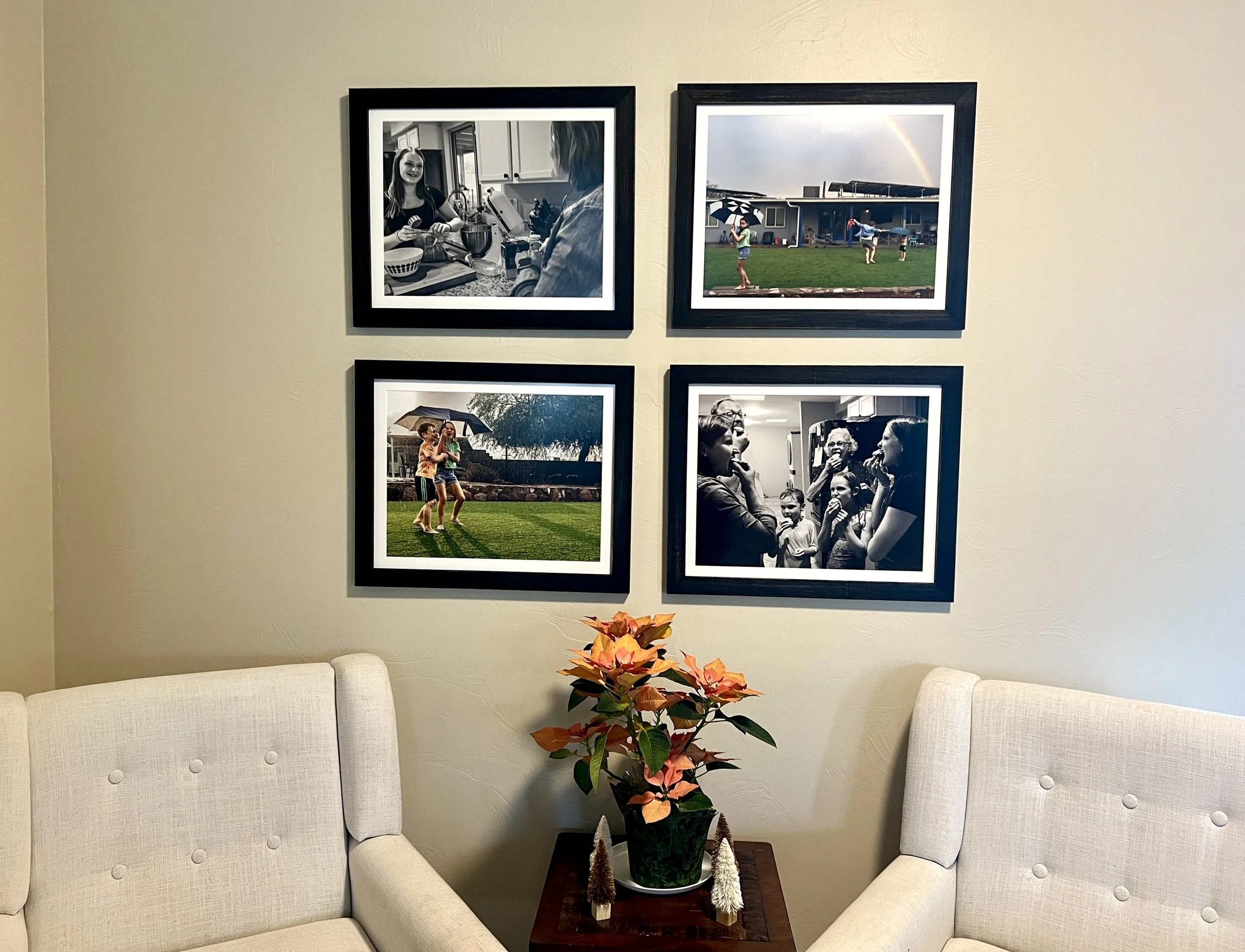 4 framed photographs of a family on a living room wall by Tucson family photographer Michelle Molnar