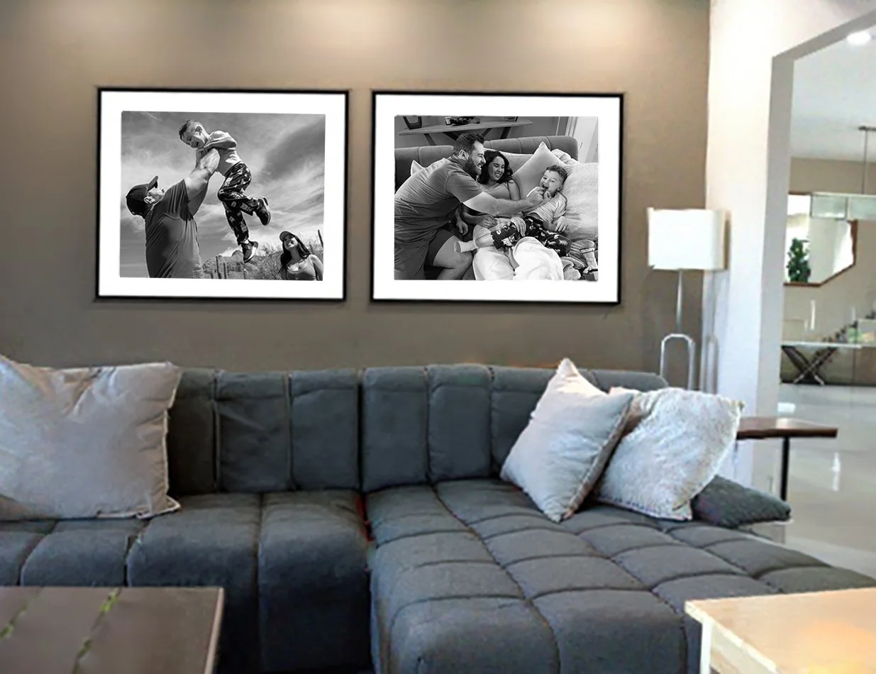 Living room with two black-and-white framed photos on the wall, a gray sectional sofa with pillows, and a floor lamp created by Tucson family photographer Michelle Molnar.