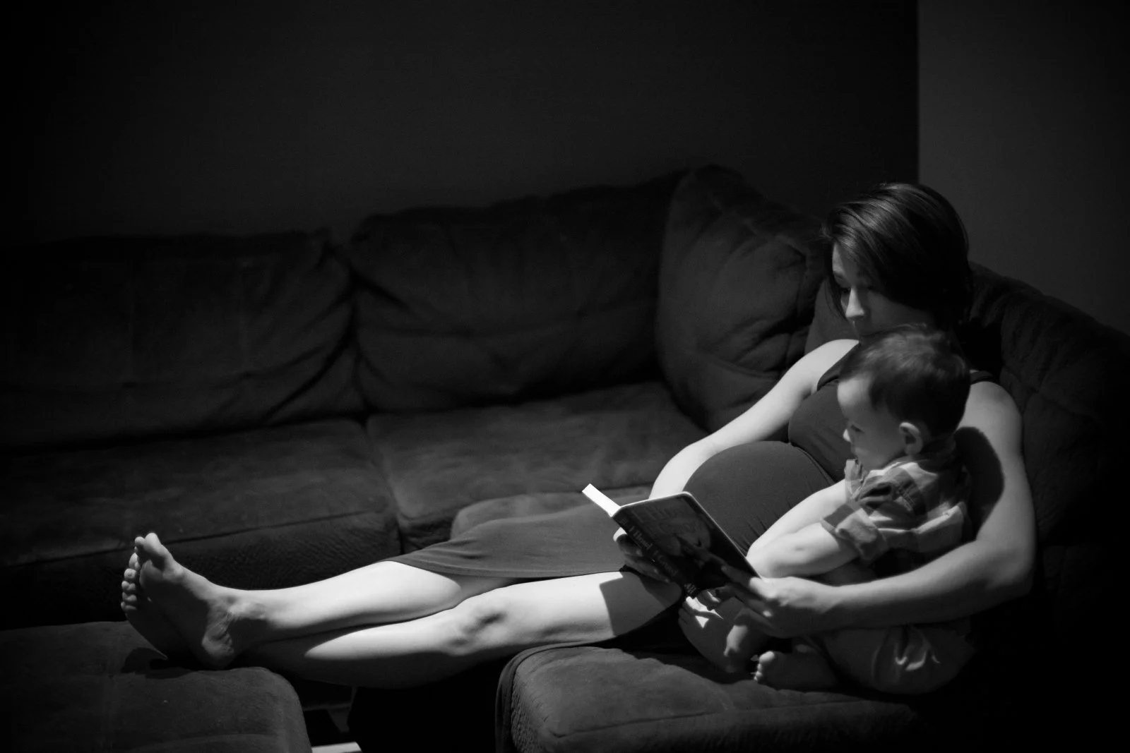 pregnant mom reads to her son photographed during a Carlsbad maternity photography session.