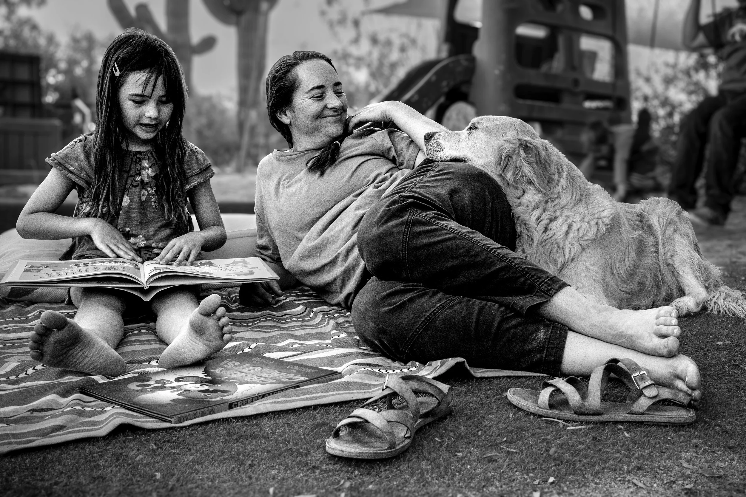 mom, daughter and dog read together during a Tucson family photography session. 