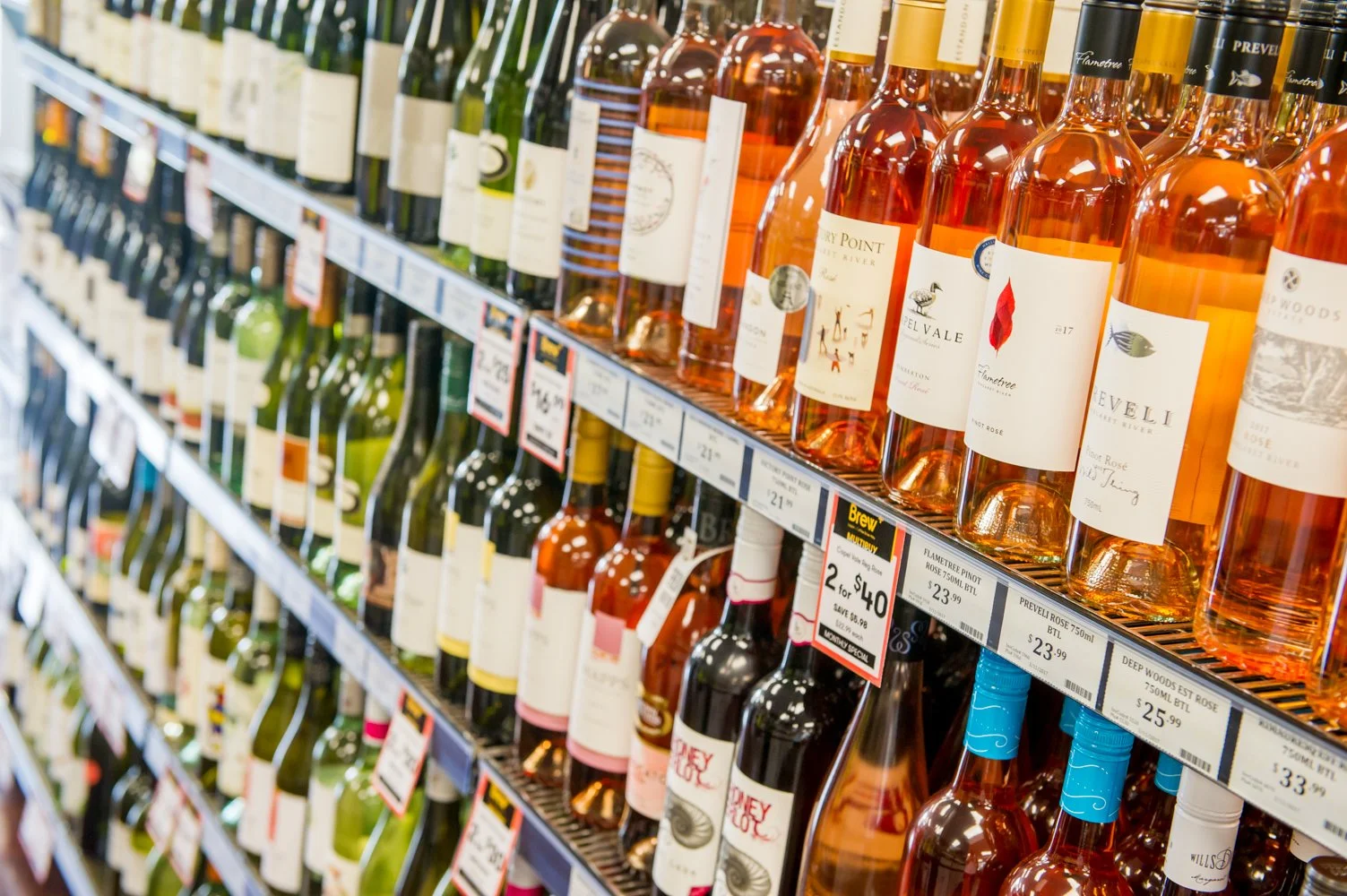 Wine bottles neatly displayed at a Busselton bottle shop, showcasing local and premium wines at Brew Plus
