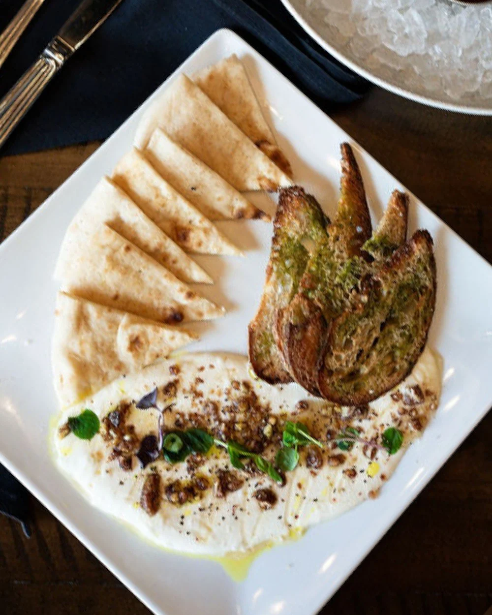 Meet our new Whipped Feta Appetizer, a bold new favorite for fall.
Rich, creamy whipped feta drizzled with honey and lemon oil, topped with spiced pecans, peppercorns, and microgreens — served with crostini and warm pita. 
Try it for yourself