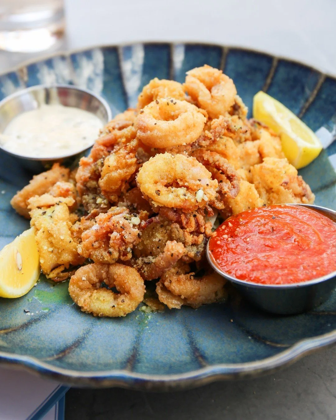 Golden and crispy with a New England twist 🦑

Our New England Calamari features lightly breaded calamari steak topped with parmesan pepper and served with house marinara, caper remoulade, lemon oil, and fresh parsley.

Perfect for the table, and eve