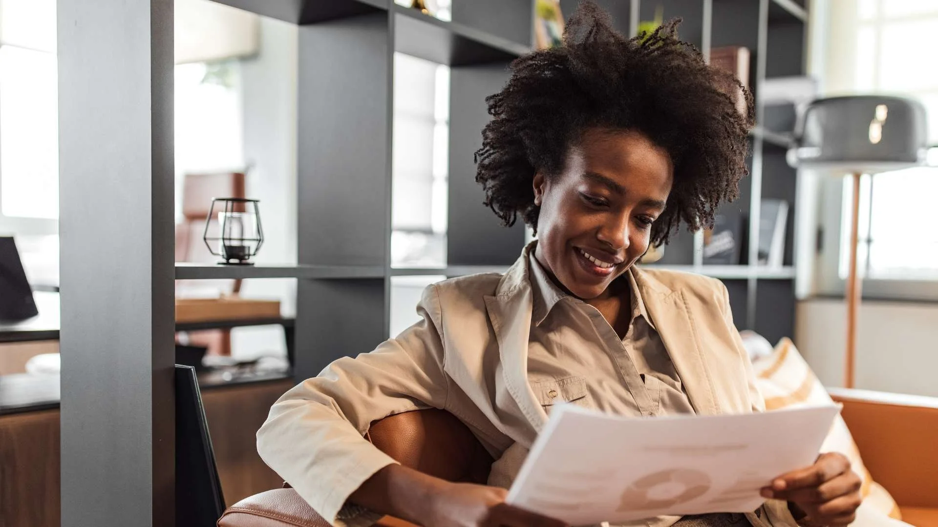 Woman sitting on a couch reviewing legal bills