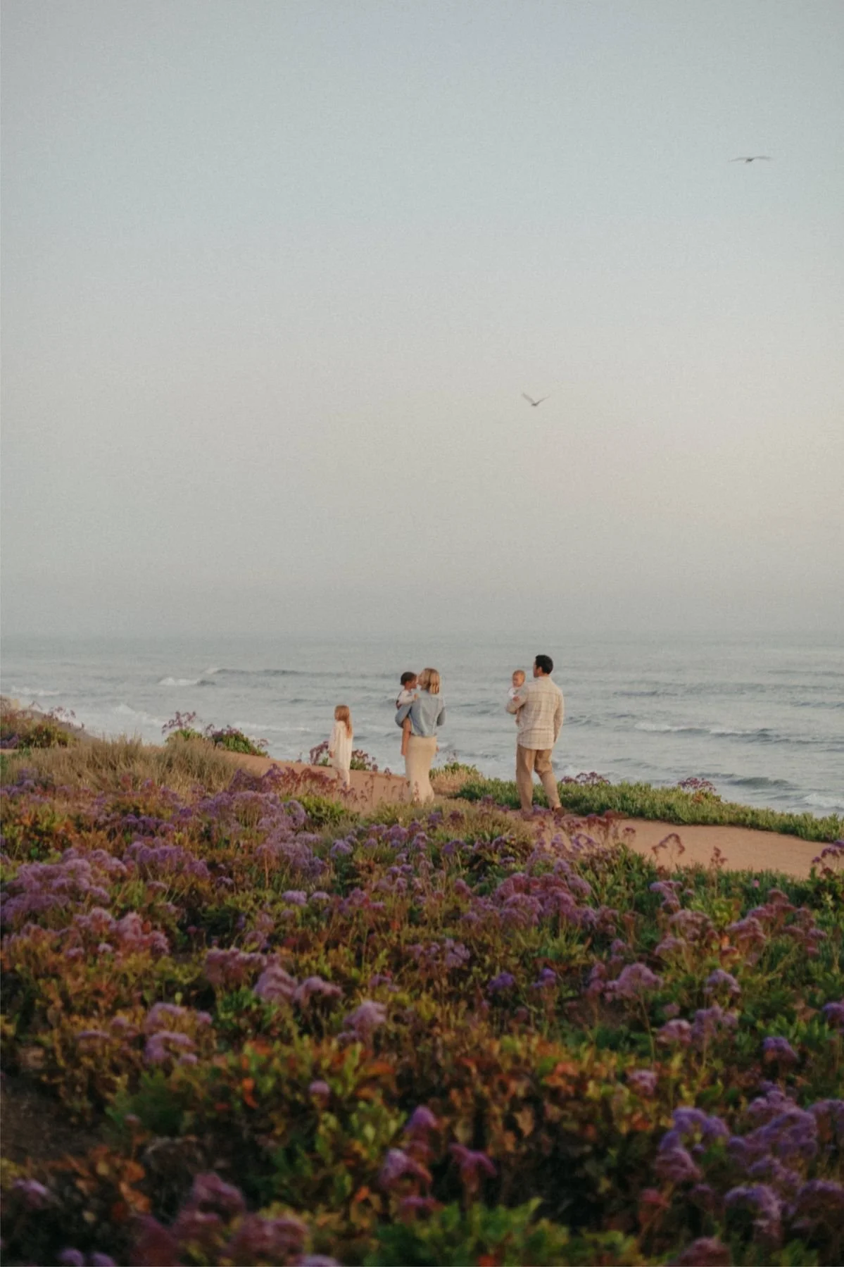family of 5 walking the coastline