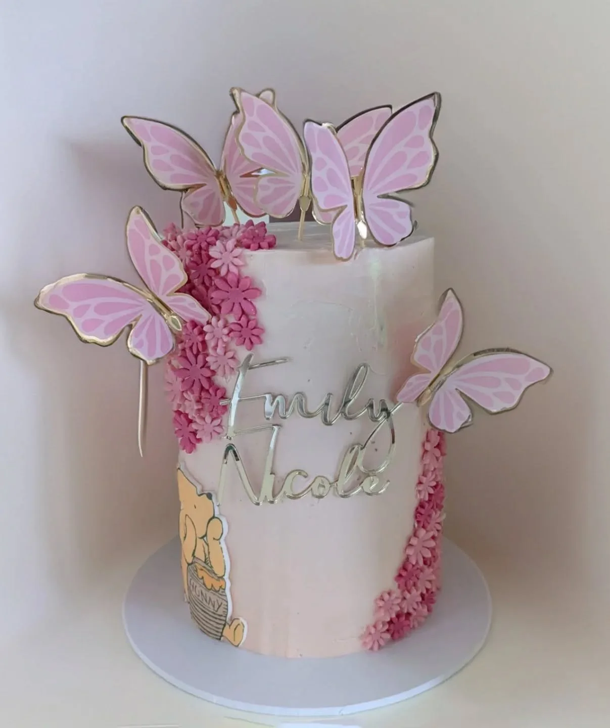 🦋 A tall vanilla beauty for Emily Nicole’s christening 🦋
🍰 Layers of soft vanilla sponge filled with cream and fresh local fruit
🩷 Wrapped in blush buttercream, topped with fluttering butterflies, hand crafted florals, and a touch of Winni