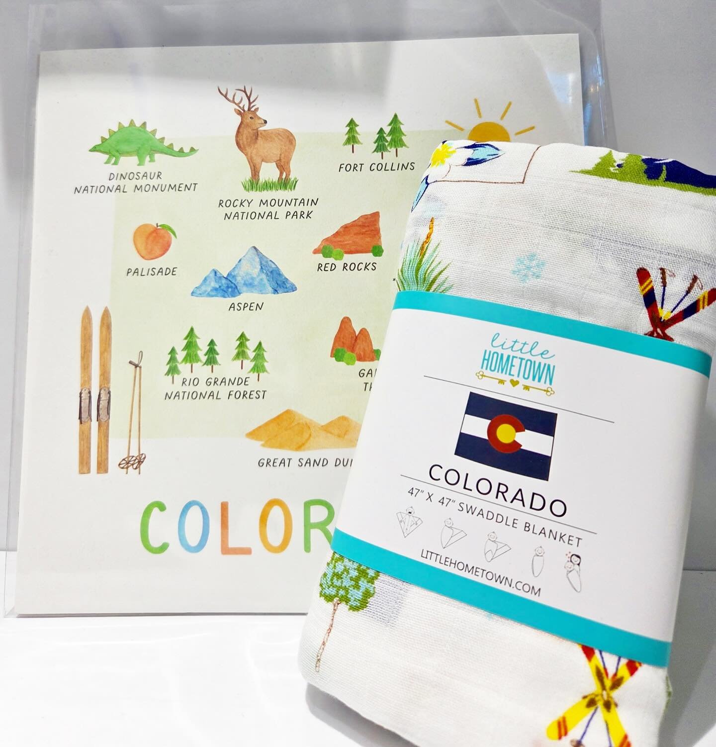 🏔️ From the Rockies to Red Rocks, this adorable swaddle blanket by @littlehometown brings the spirit of the Centennial State to your little one. Paired with a charming watercolor print of Colorado&rsquo;s iconic spots by @shopamyzhang &mdash; it&rsq