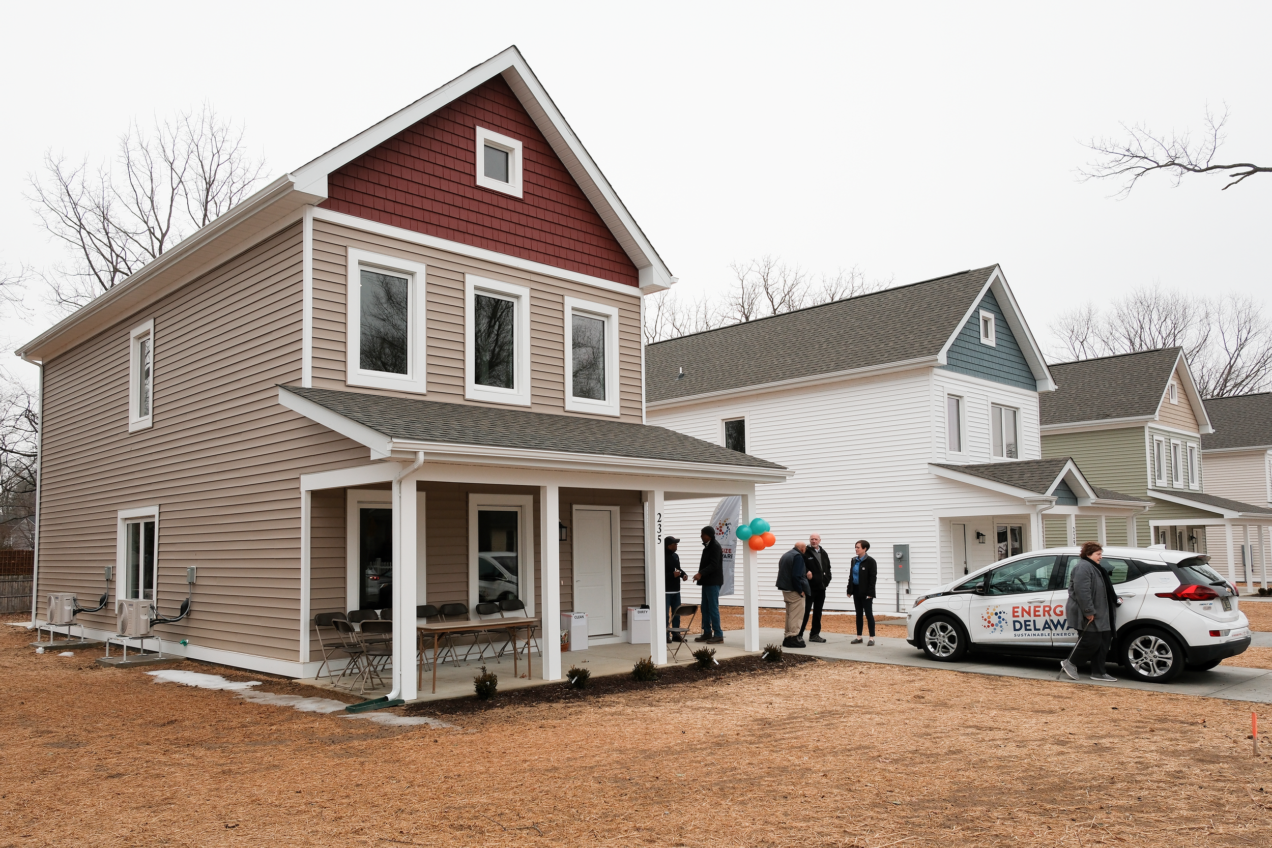 Exterior of new homes and an Energize Delaware car in the driveway