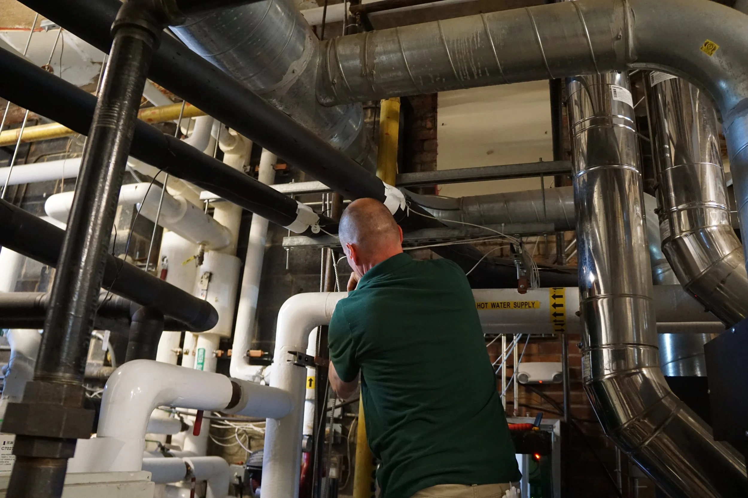 Sean piping boiler room NEI shirt 2.JPG