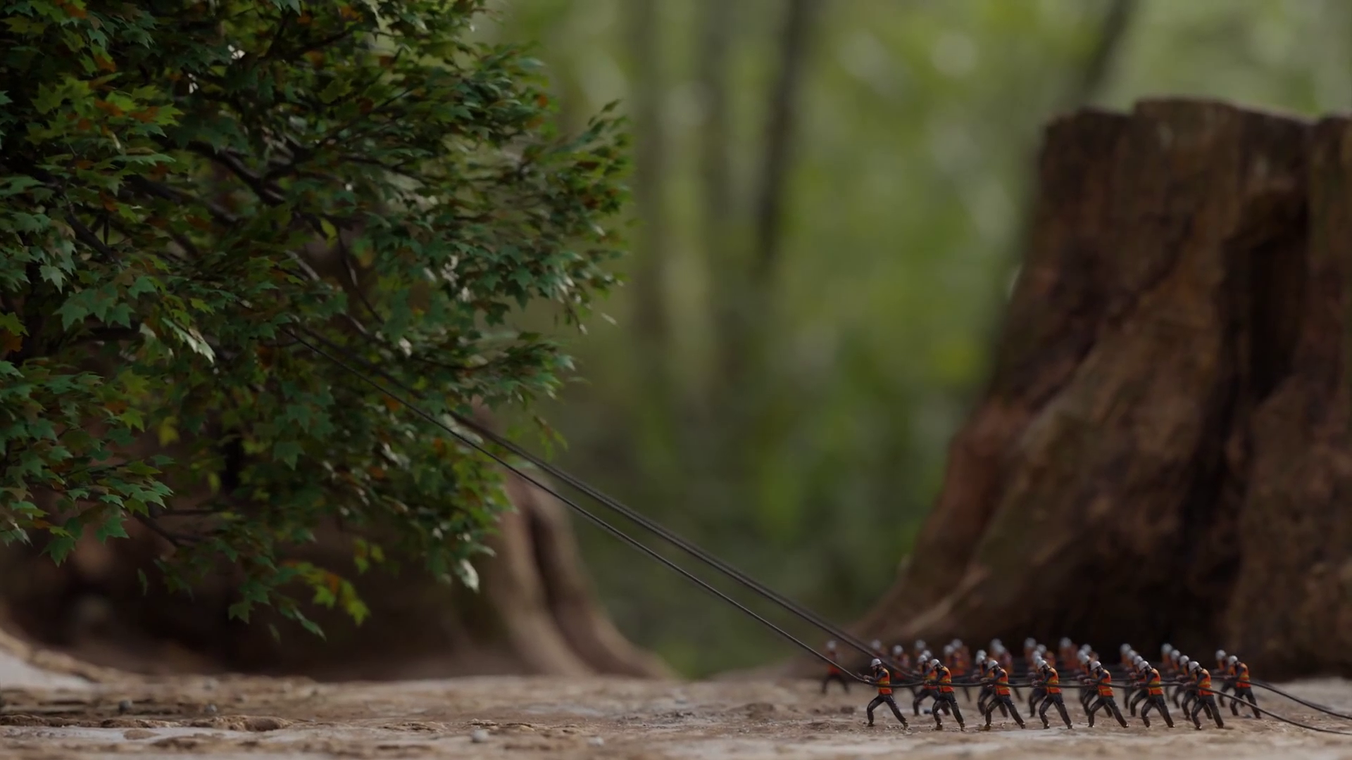 Miniature workers are pulling cables, possibly to anchor or position a structure, surrounded by a forest-like backdrop.
