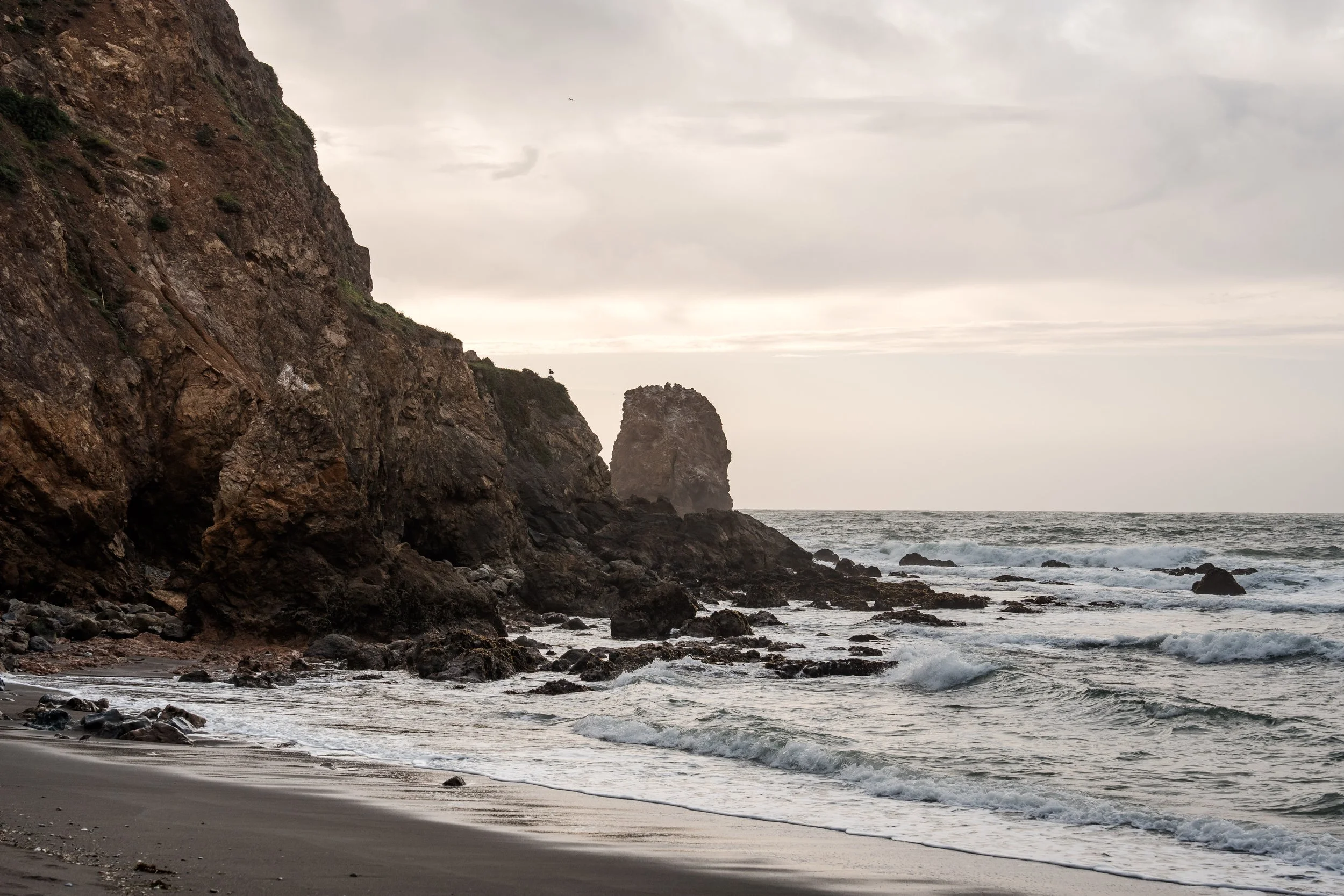 Pacifica coastline cliffs and waves, symbolizing mindfulness and ecotherapy at Deep Dive Therapy.