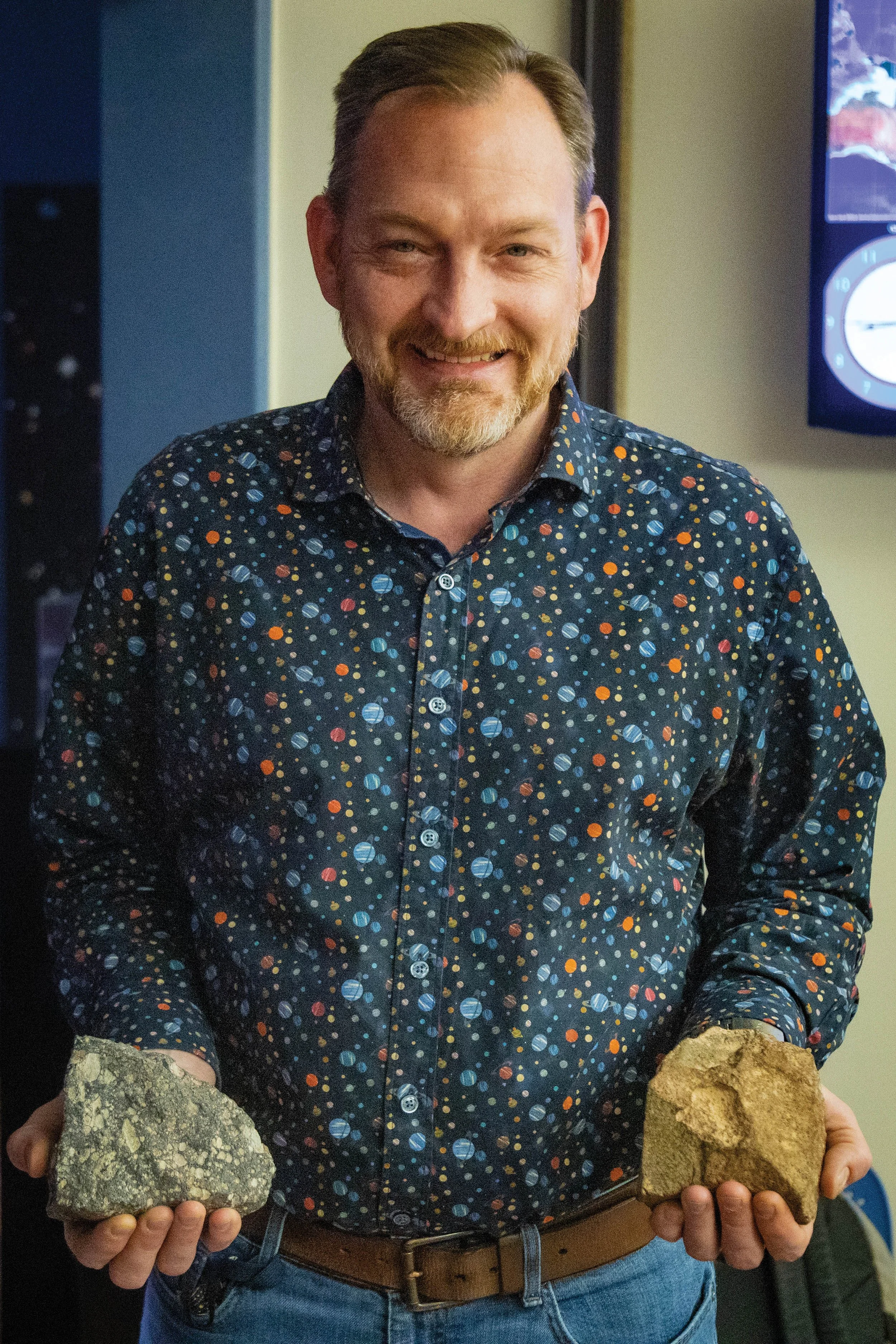 Shawn Laatsch wearing a shirt with the solar system.