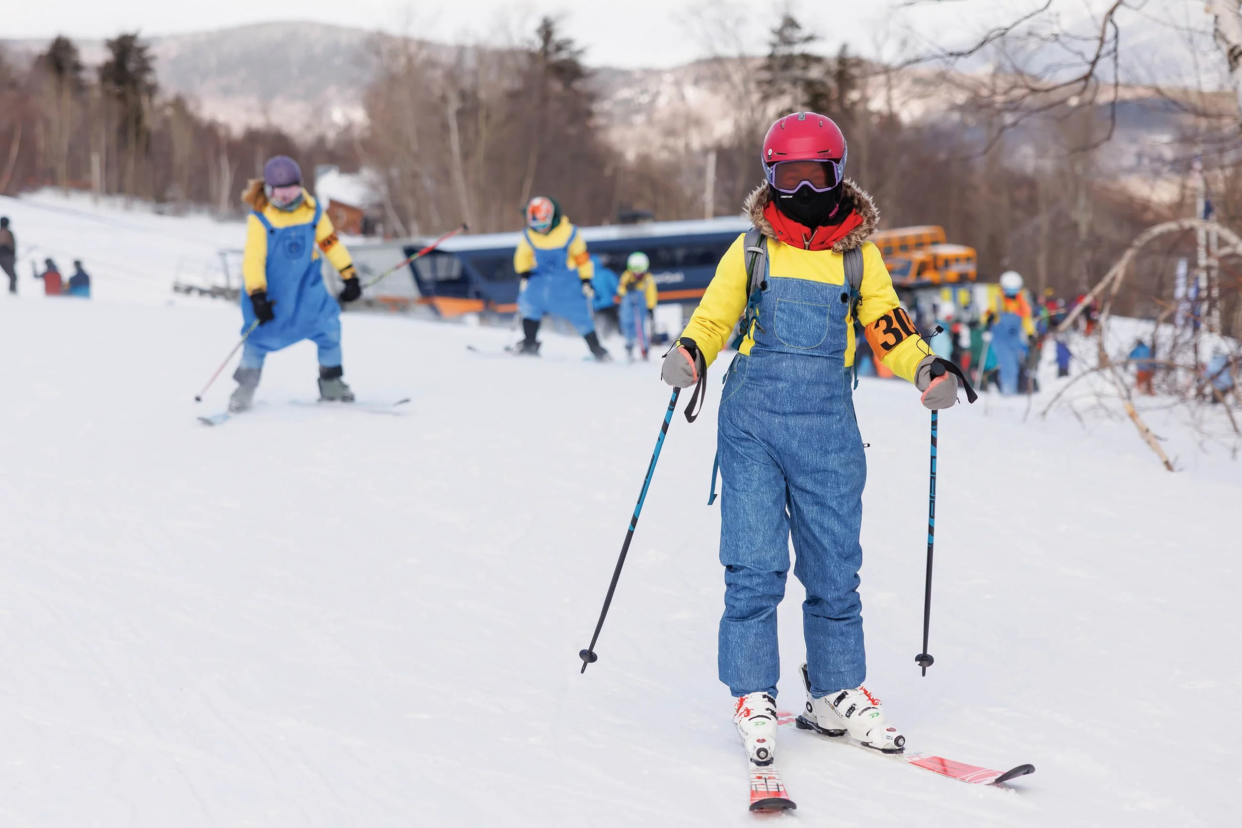 Child with helmet and ski equipment on a ski slope.