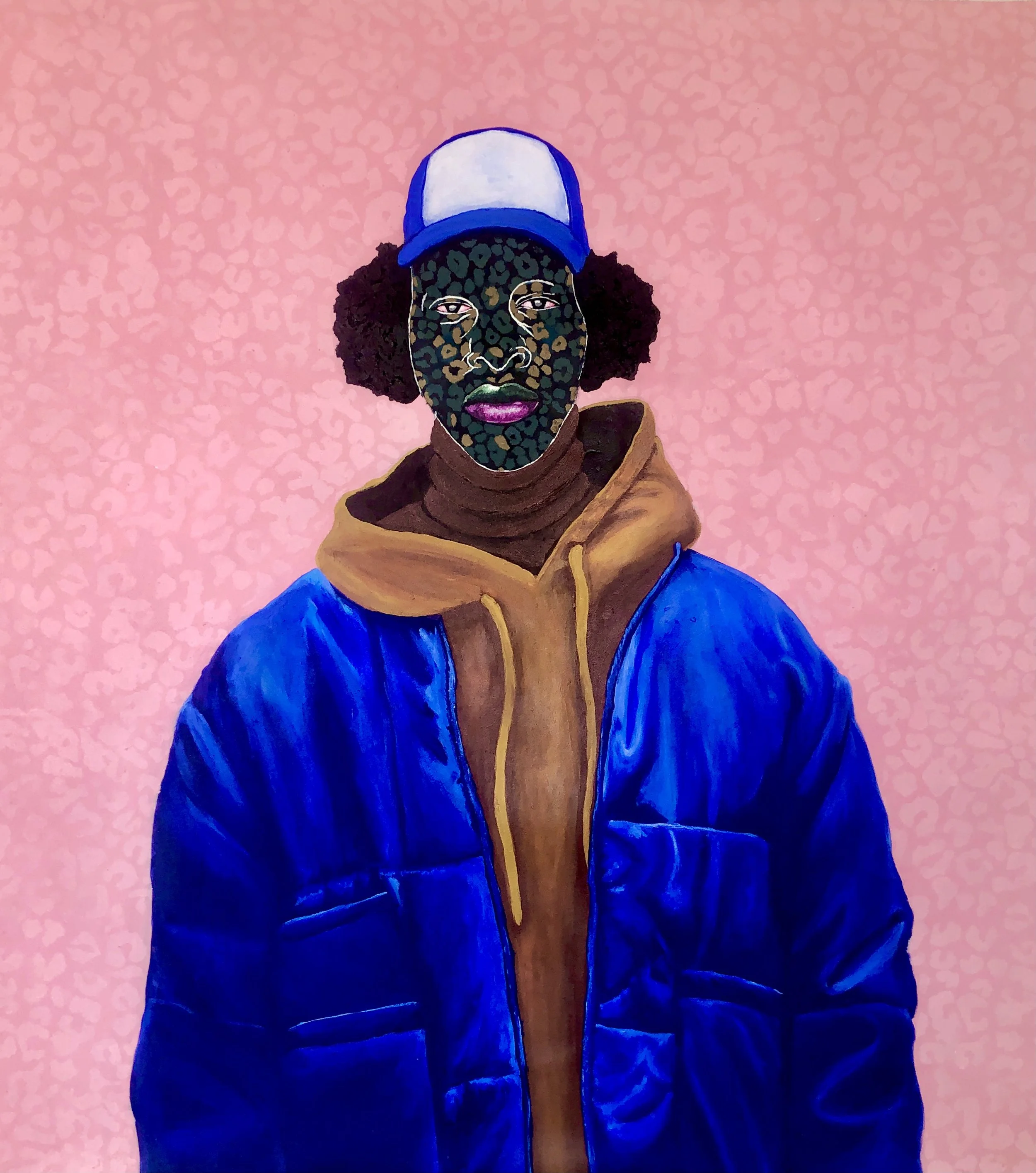 A person wearing a blue and white trucker hat, with curly black hair visible on the sides, a colorful leopard print face covering, a brown turtleneck sweater, and a blue jacket, standing against a pink, patterned background.
