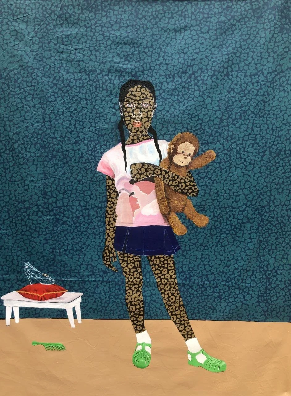 A girl with leopard print skin holding a teddy bear, standing in front of a blue patterned background. She wears a pink and white shirt, a blue skirt, white socks, and green sandals. There is a small table with a red pillow and a decorative wire sculpture on it, and a small green brush on the floor.