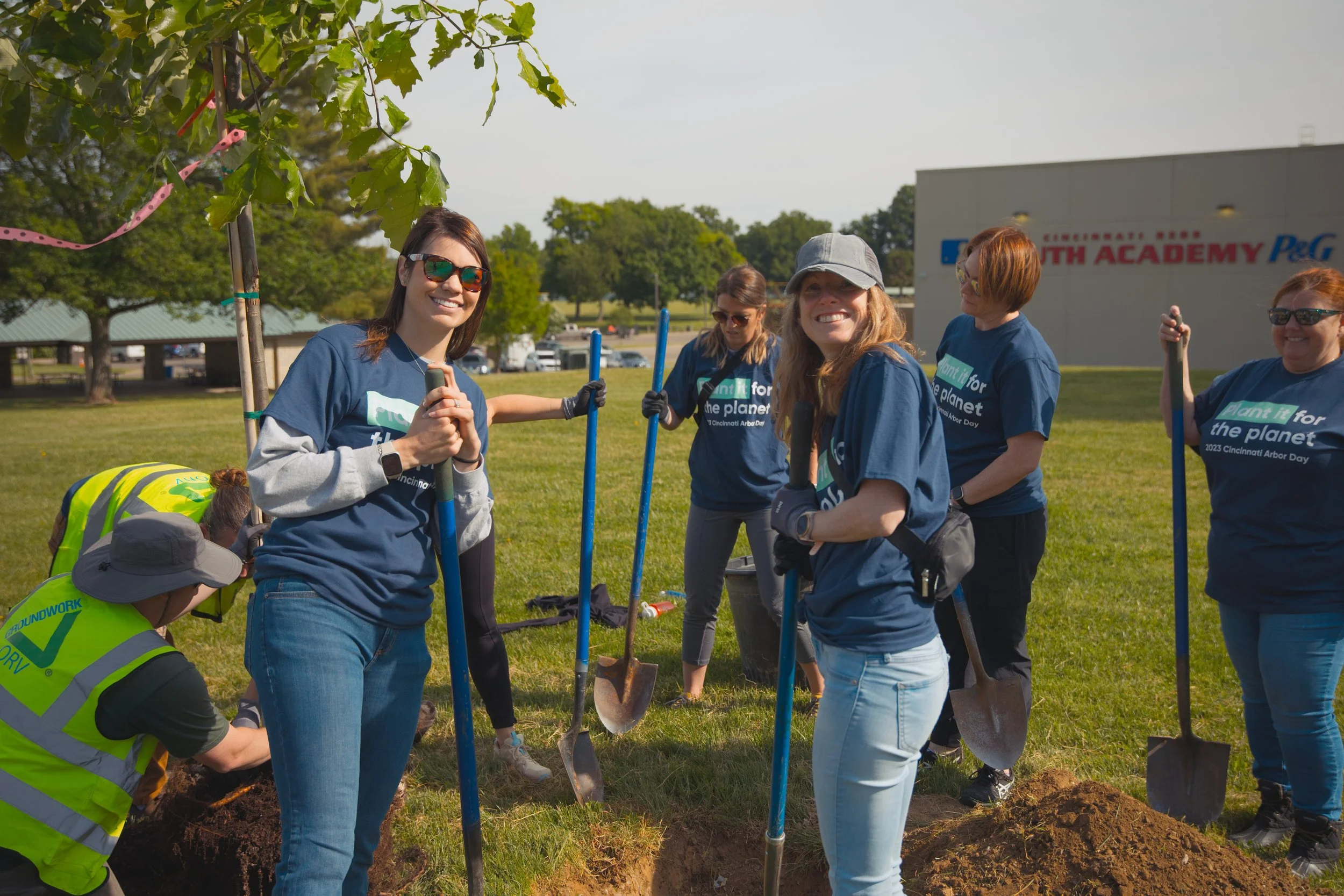 Impactful imagery of company team members posing and smiling at a corporate charity event.