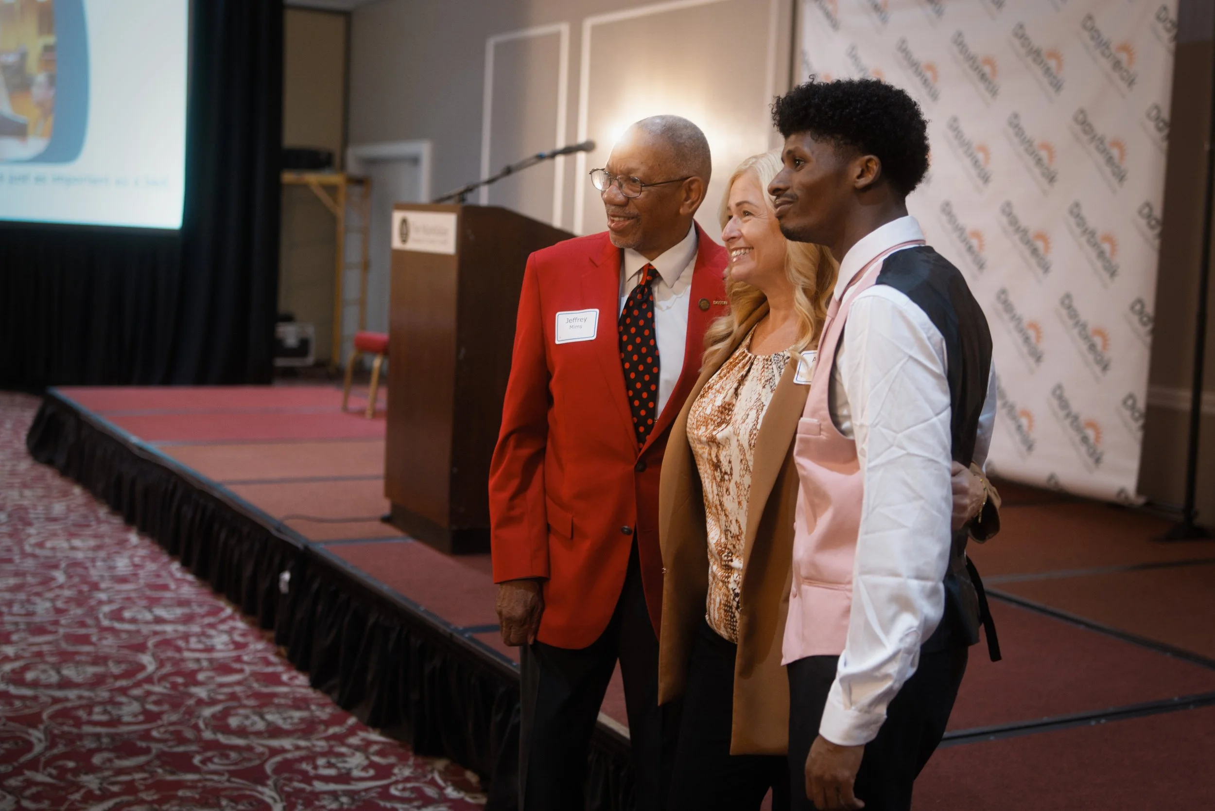 Dayton Mayor, nonprofit organization President, and keynote speaker pose together for professional photographers with soft lighting