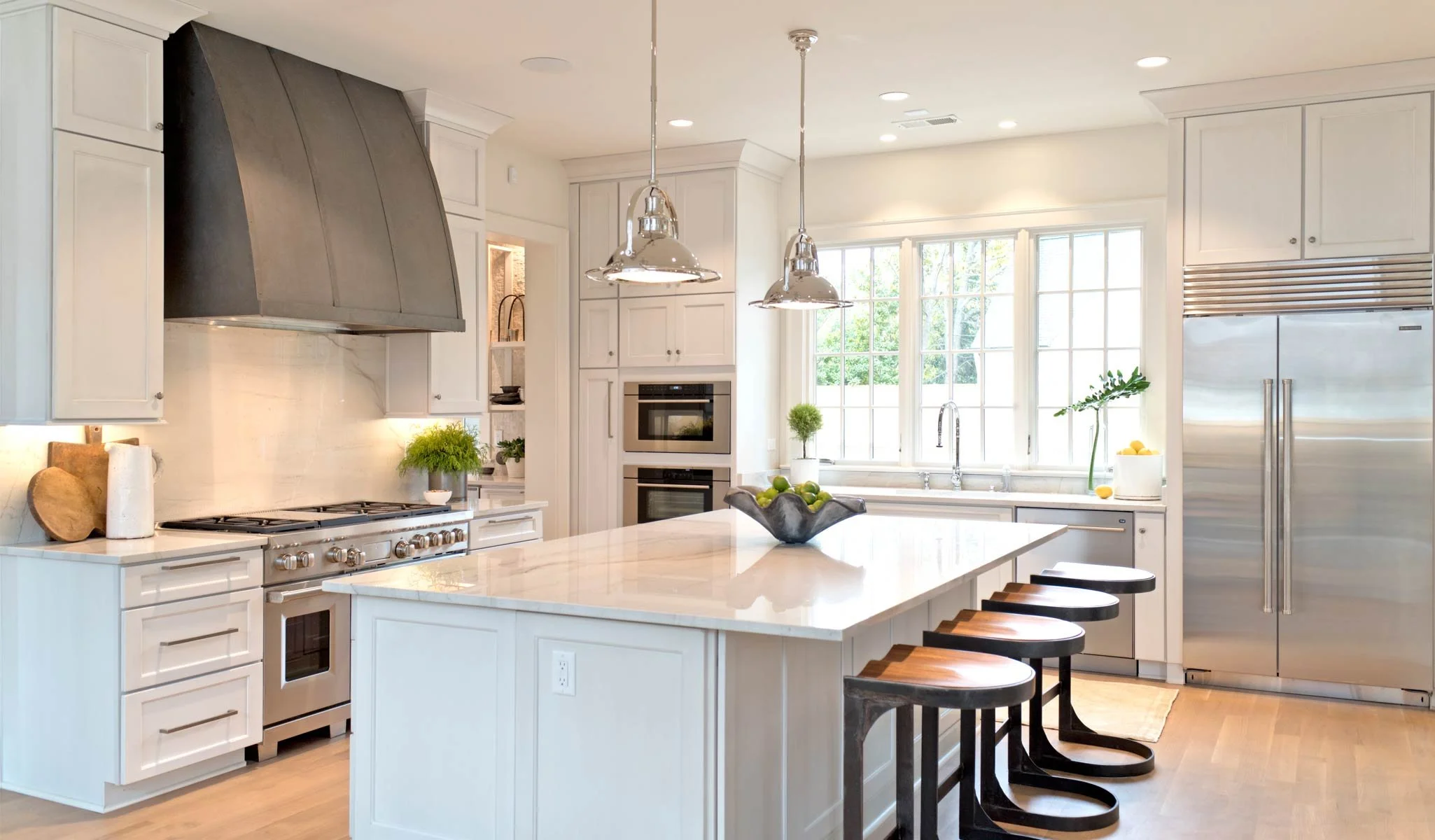 White kitchen cabinets with dark range hood
