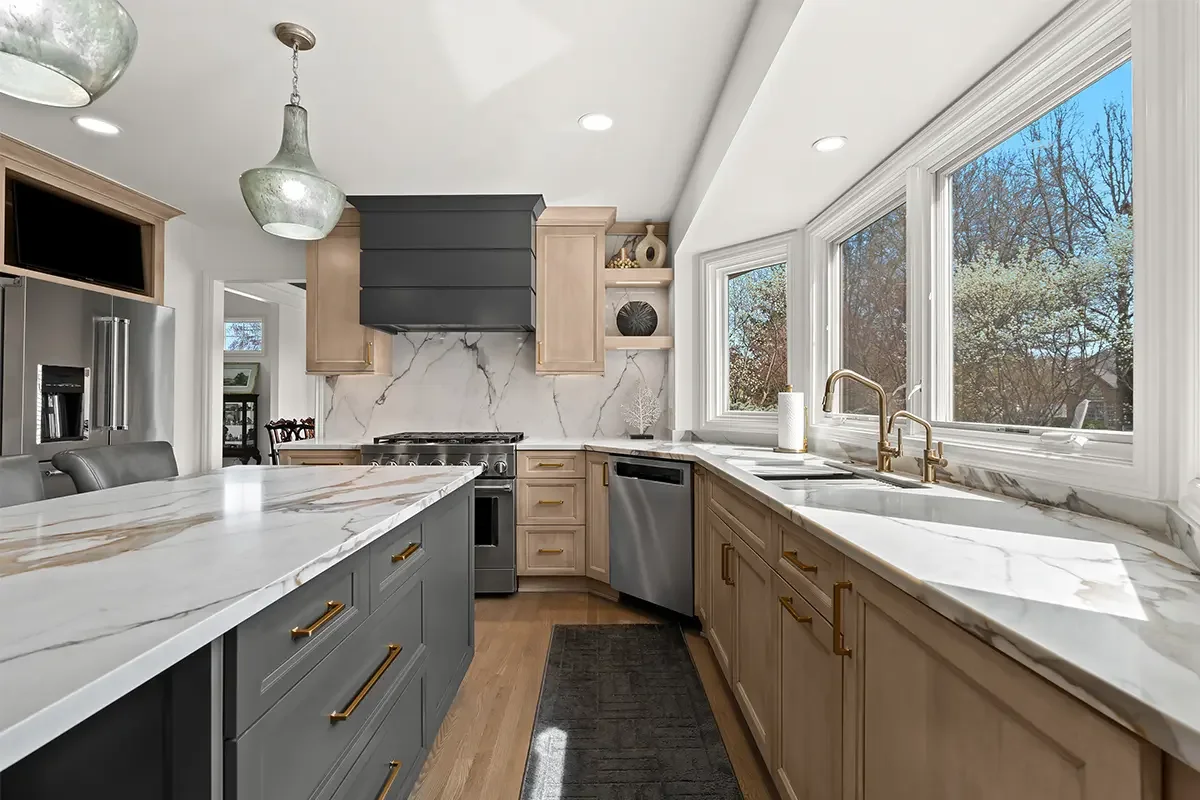 Kitchen cabinetry featuring gold knobs and pulls in different sizes and placements across doors and drawers