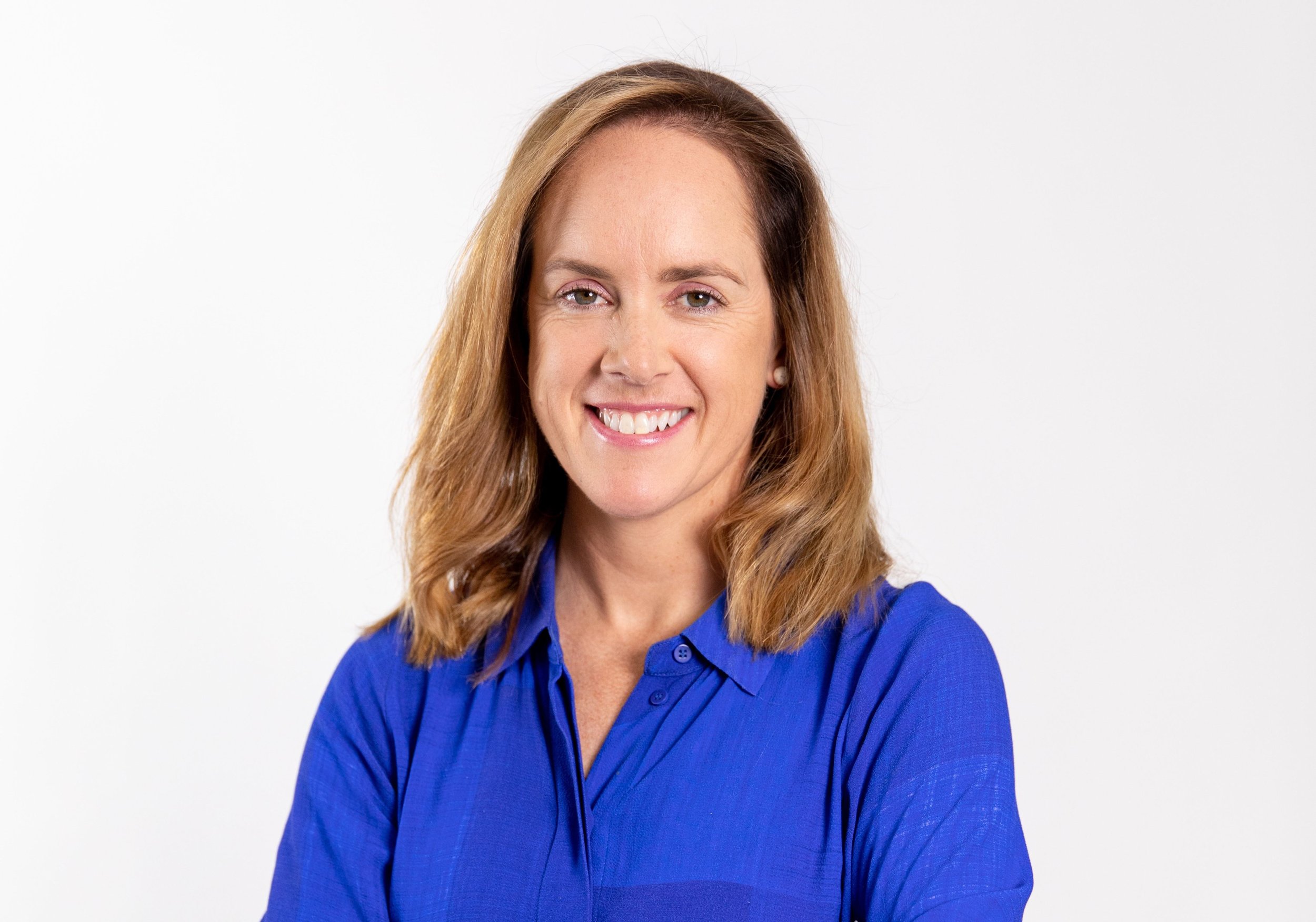 Libby Owens profile image showing shoulder-length blonde hair wearing a blue blouse, against a plain white background.