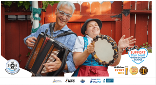 Two cheerful musicians, an older man playing an accordion and a young woman with a tambourine, perform outdoors in front of a red fence.