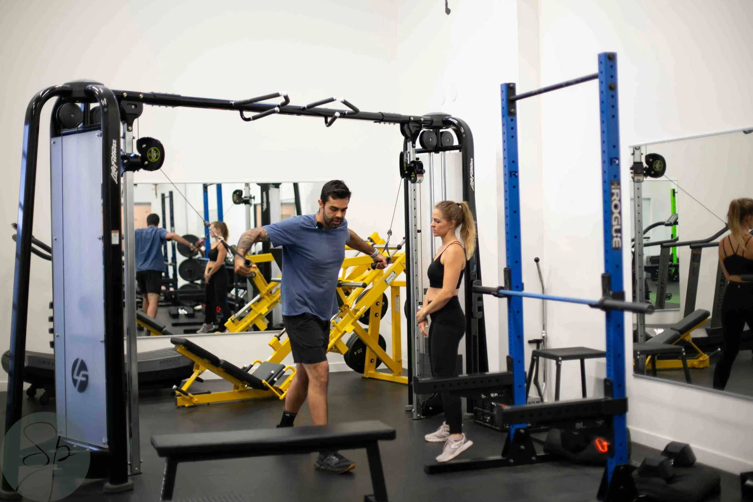 personal trainer guiding a client through a strength training session at lifestudio in north+ vancouver