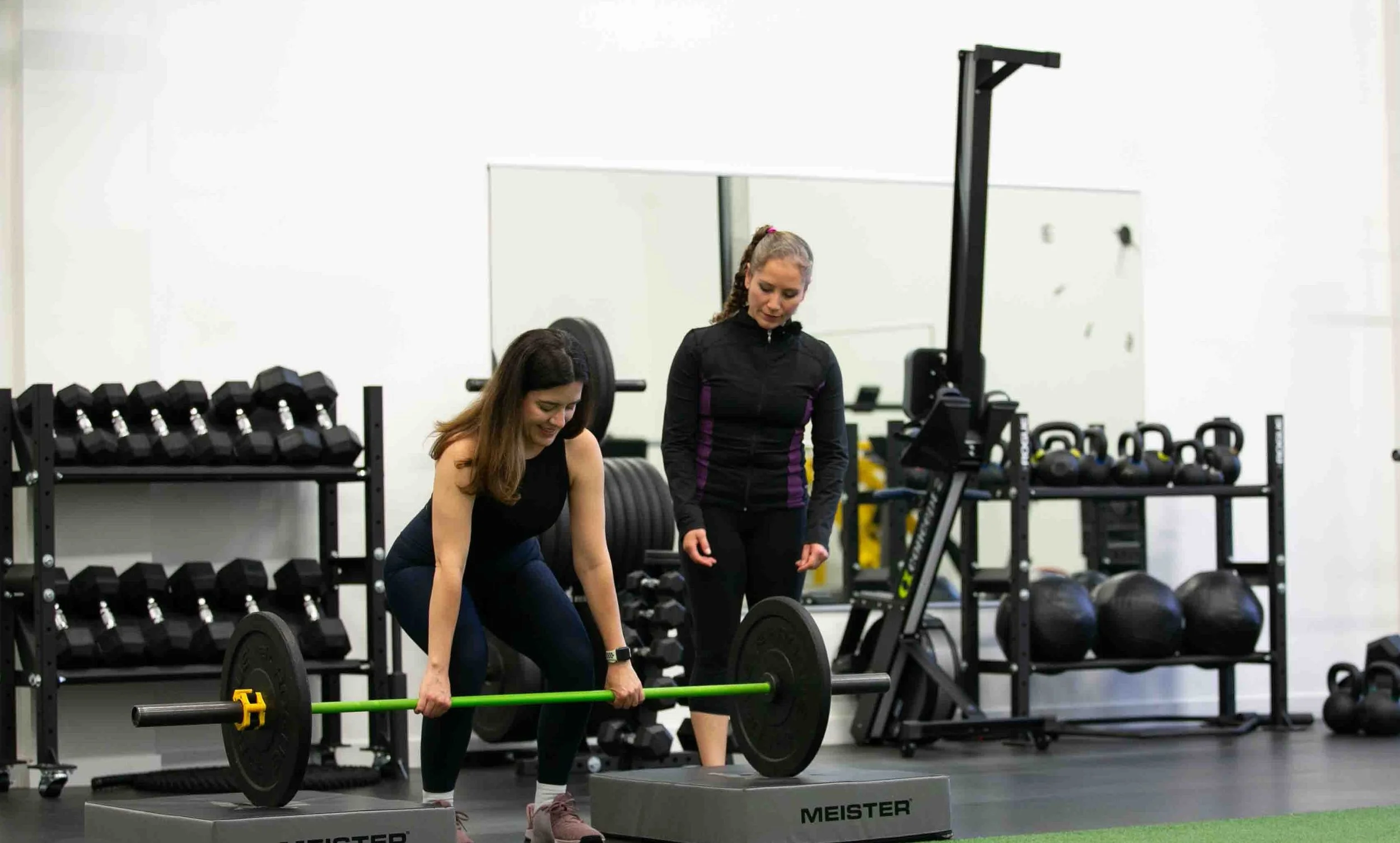 personal fitness trainer helping client with tailored workout plan to reach fitness goals in north vancouver