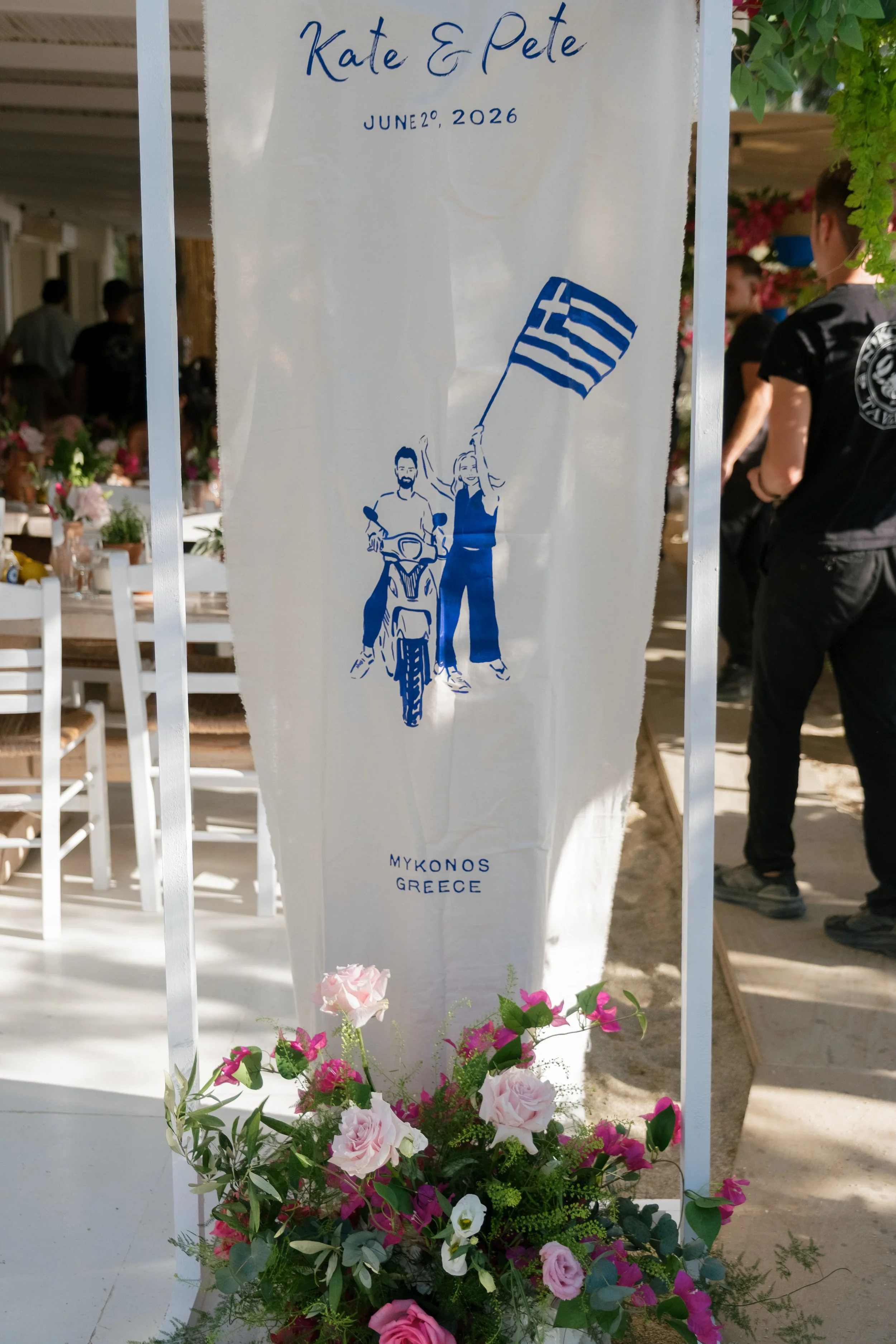 A custom wedding sign with illustrations of a couple in Mykonos, Greece