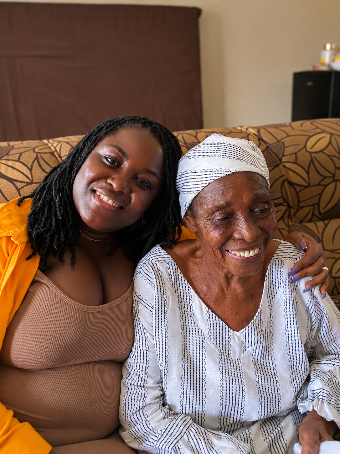 Alice sitting closely with her grandmother, Alice Birago, during their last visit together in Ghana in January 2024.