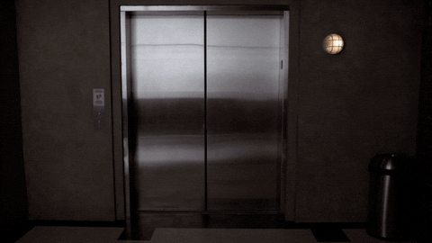 Elevator door opens with kissing couple GIF