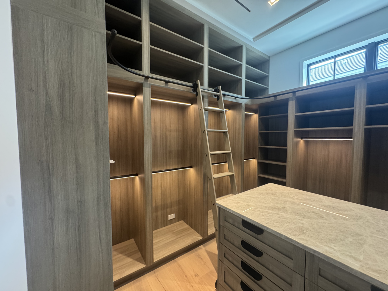warm coastal closet with ladder