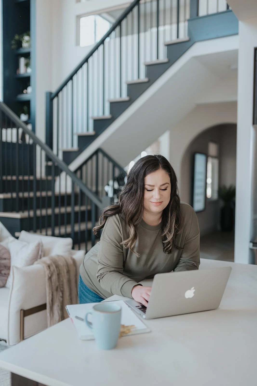 alysha in house working on laptop