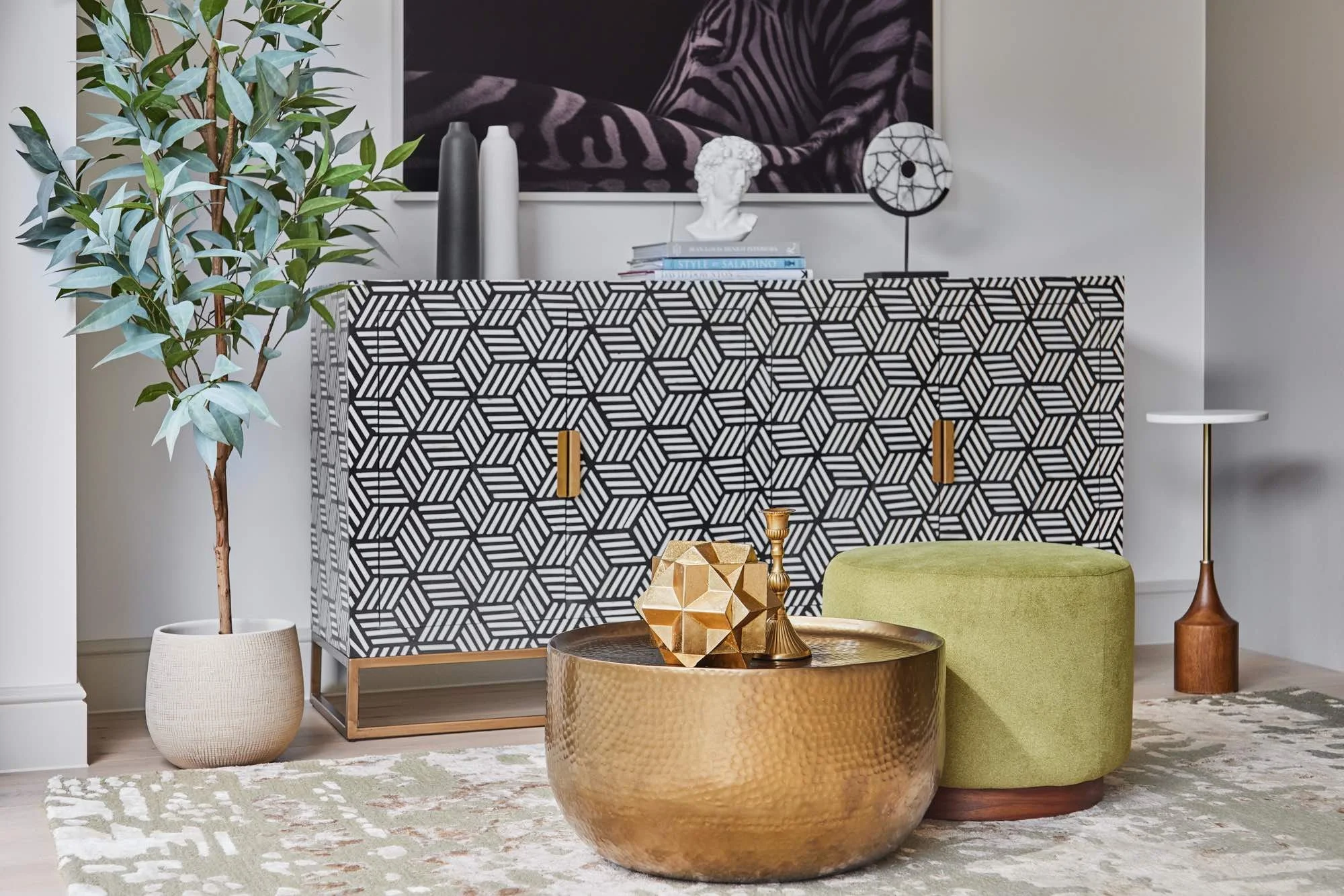 Luxury living room interior design in Wimbledon by Mond Design Interiors with green ottoman, gold coffee table, and geometric sidetable.