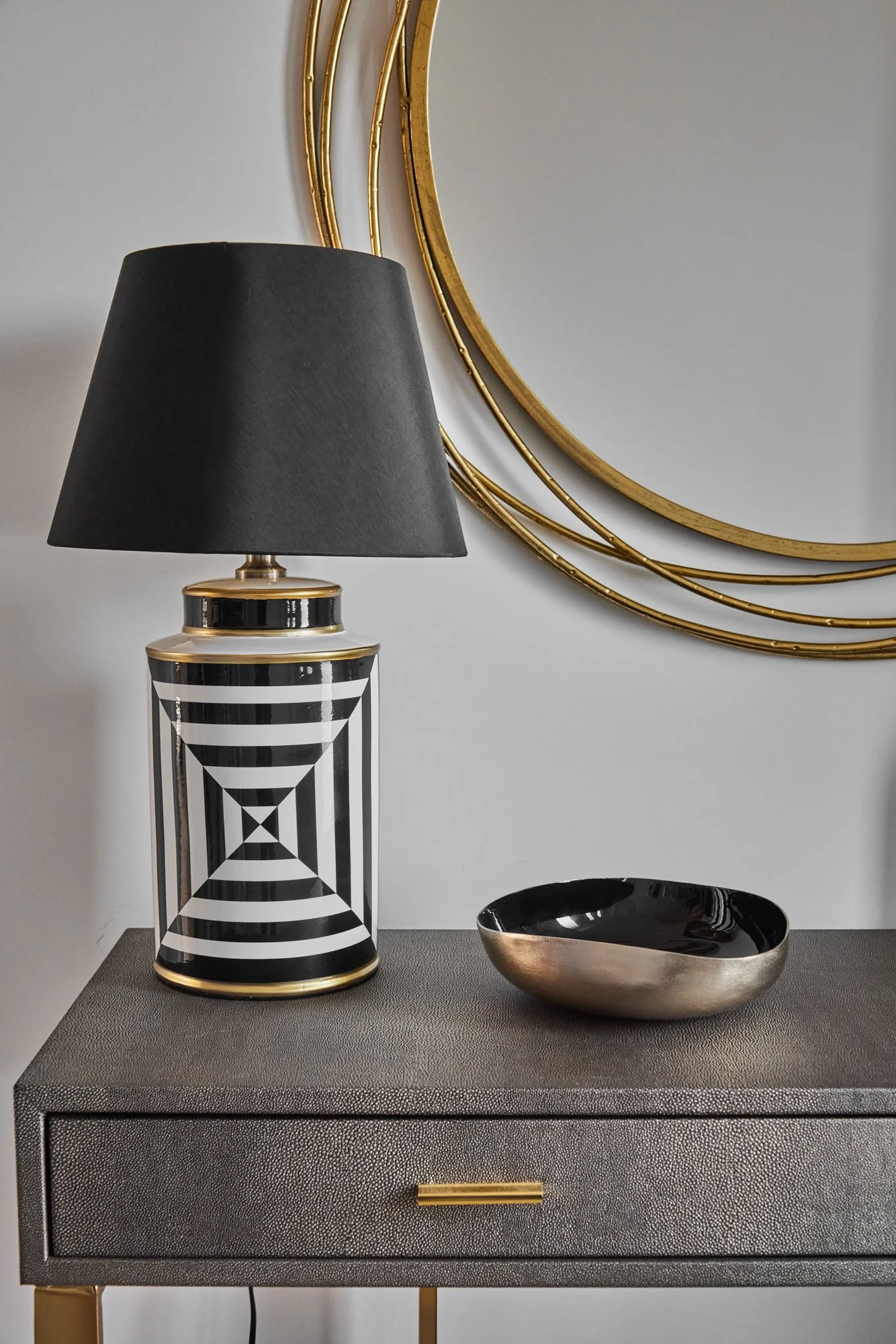 Entrance interior in Wimbledon featuring a console with a black and white table lamp and stylish decorative accents. A contemporary and welcoming space combining functionality with modern design.