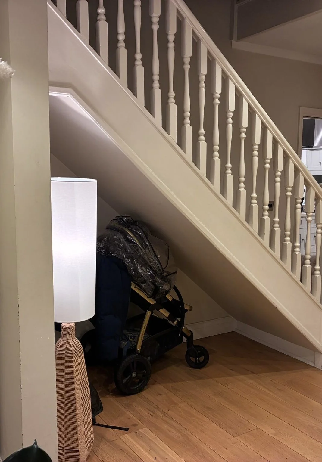 Under-stairs space used for storage before renovation, Wimbledon family home