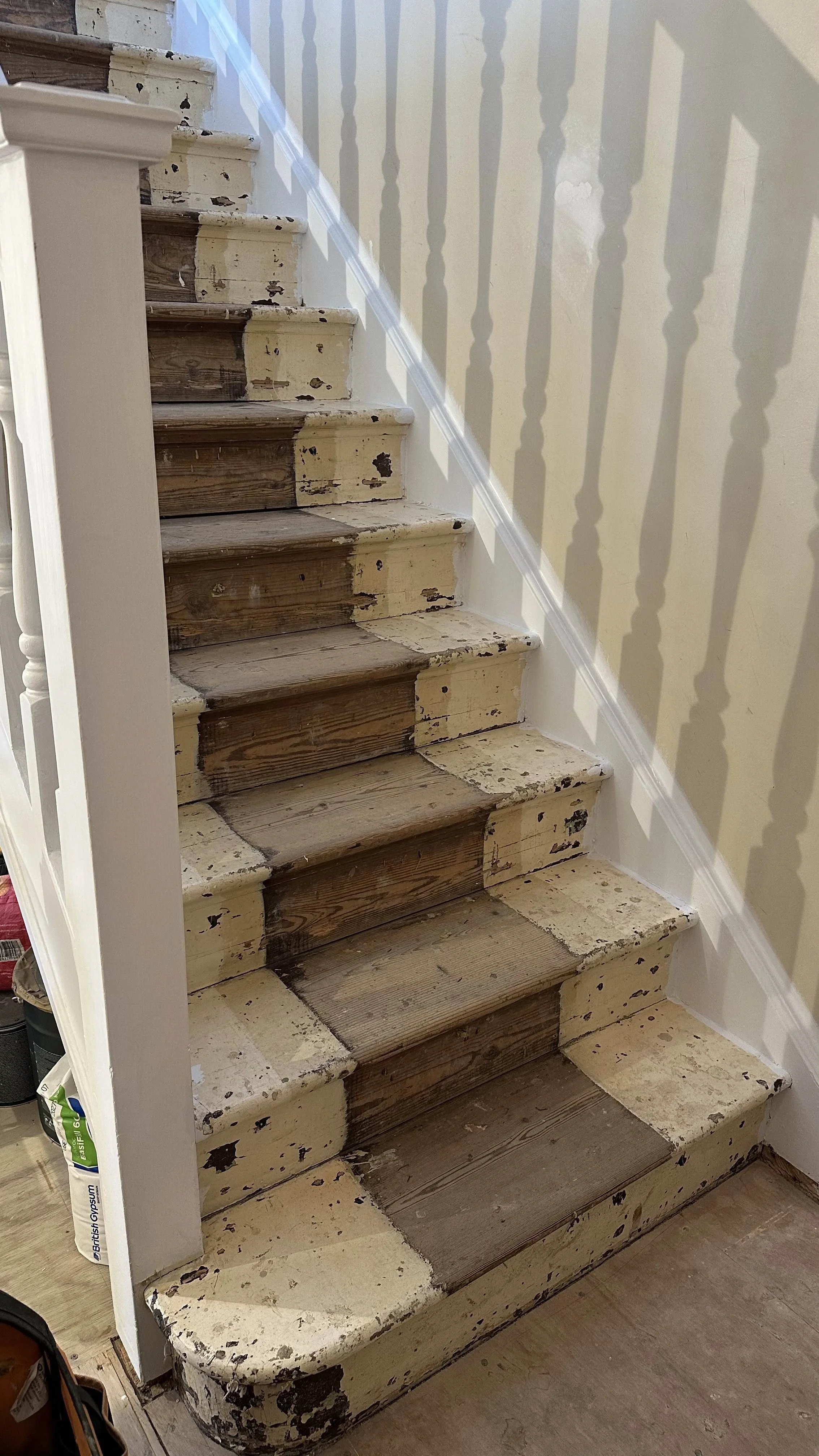 Staircase stripped back to bare wood before renovation, Wimbledon