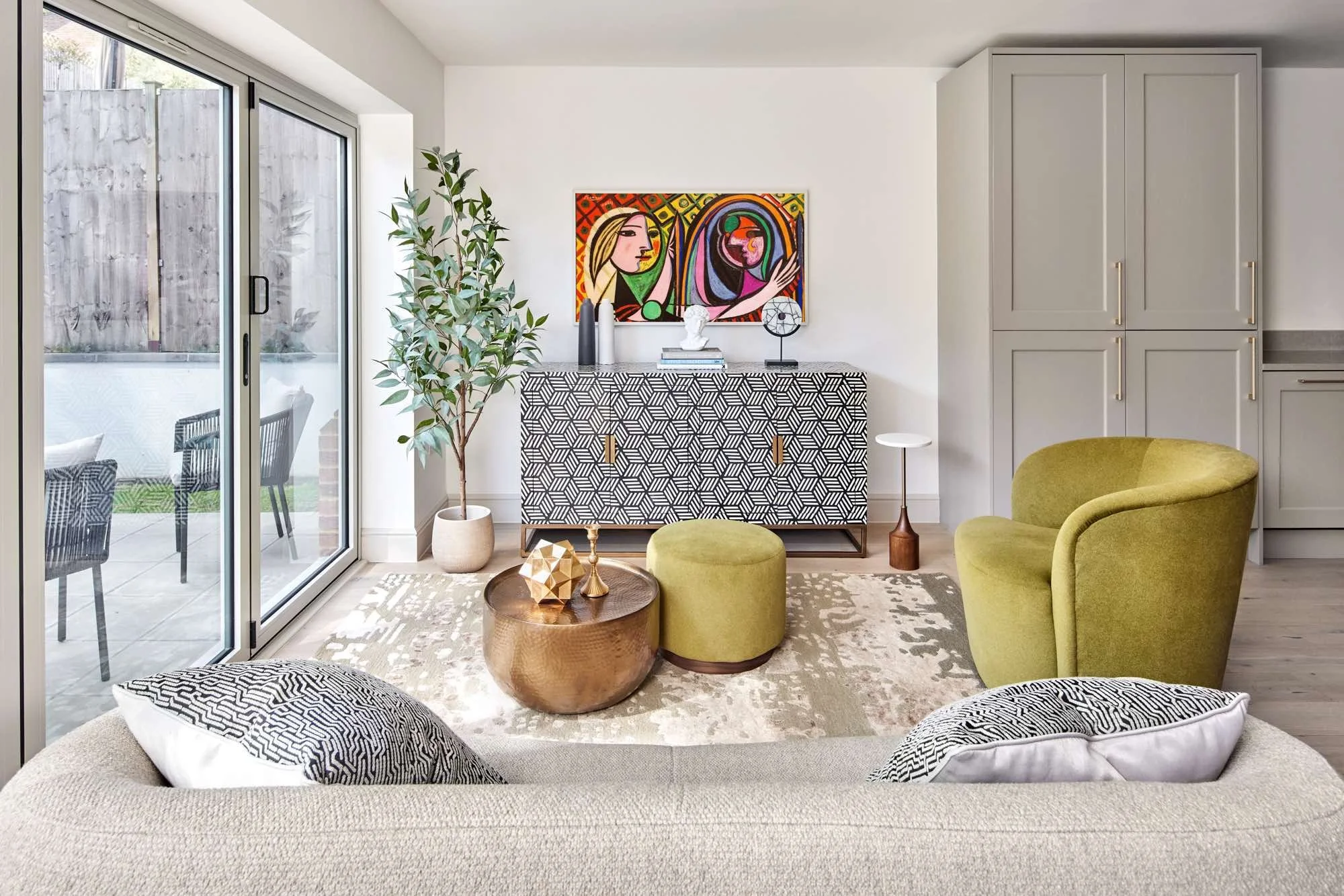 tv area with curled sofa, samsung frame tv, neutral colours