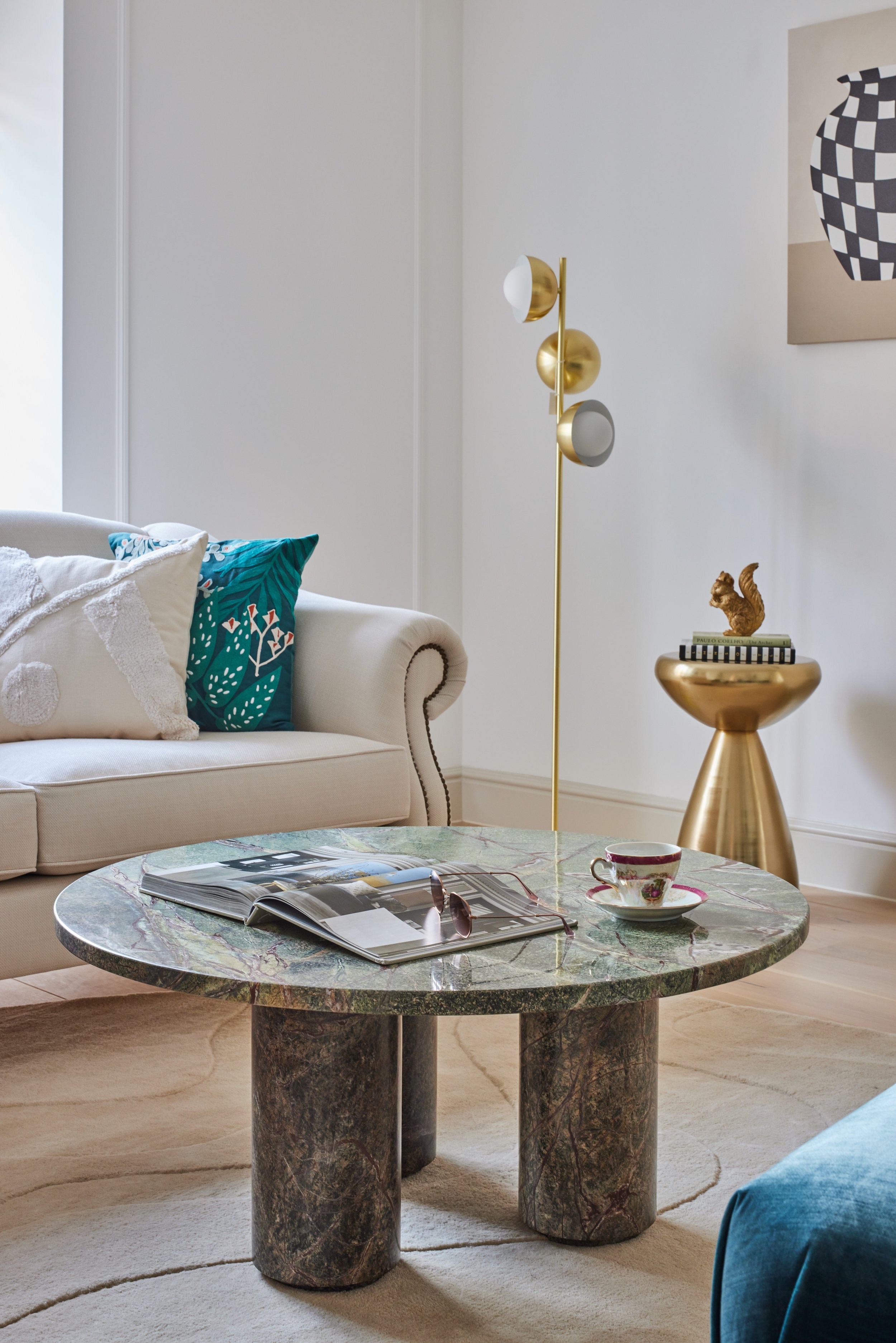 green marble coffee table and white sofa