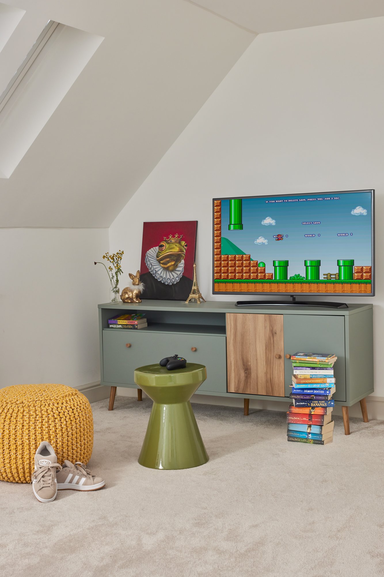 Wimbledon teenage bedroom with TV and PlayStation area, storage, pouf, and side table.
