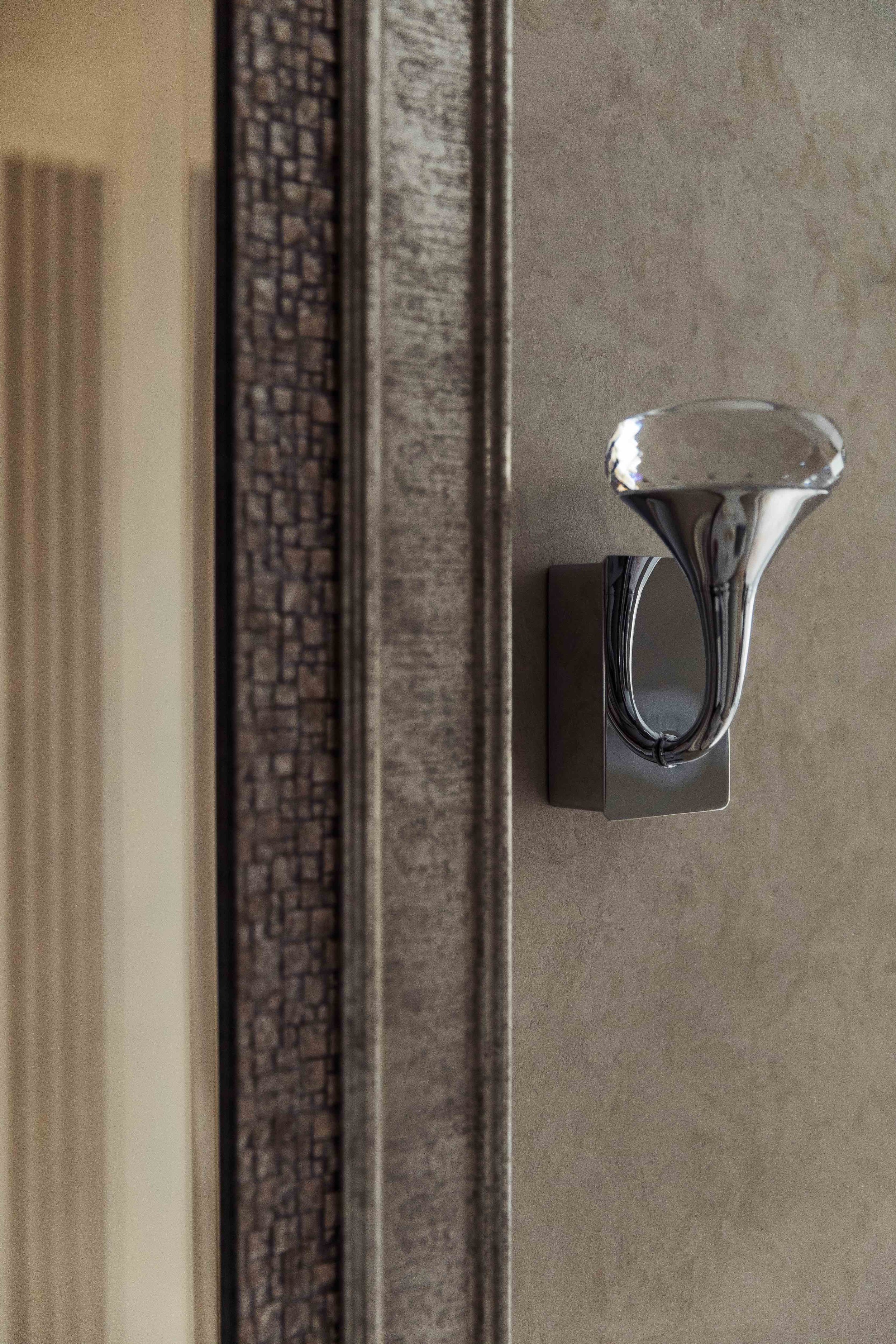 A wall light in our Wimbledon project.  A chrystal scone light mounted on the wall.