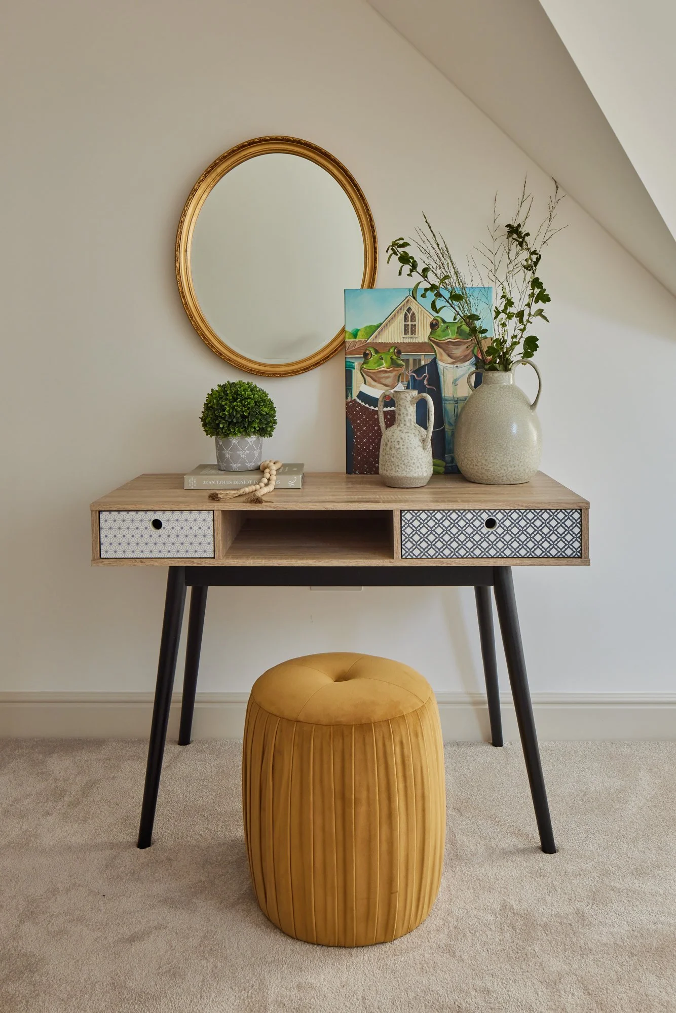 Wimbledon contemporary interior with console table, mirror, decorative plant, and minimalist décor.