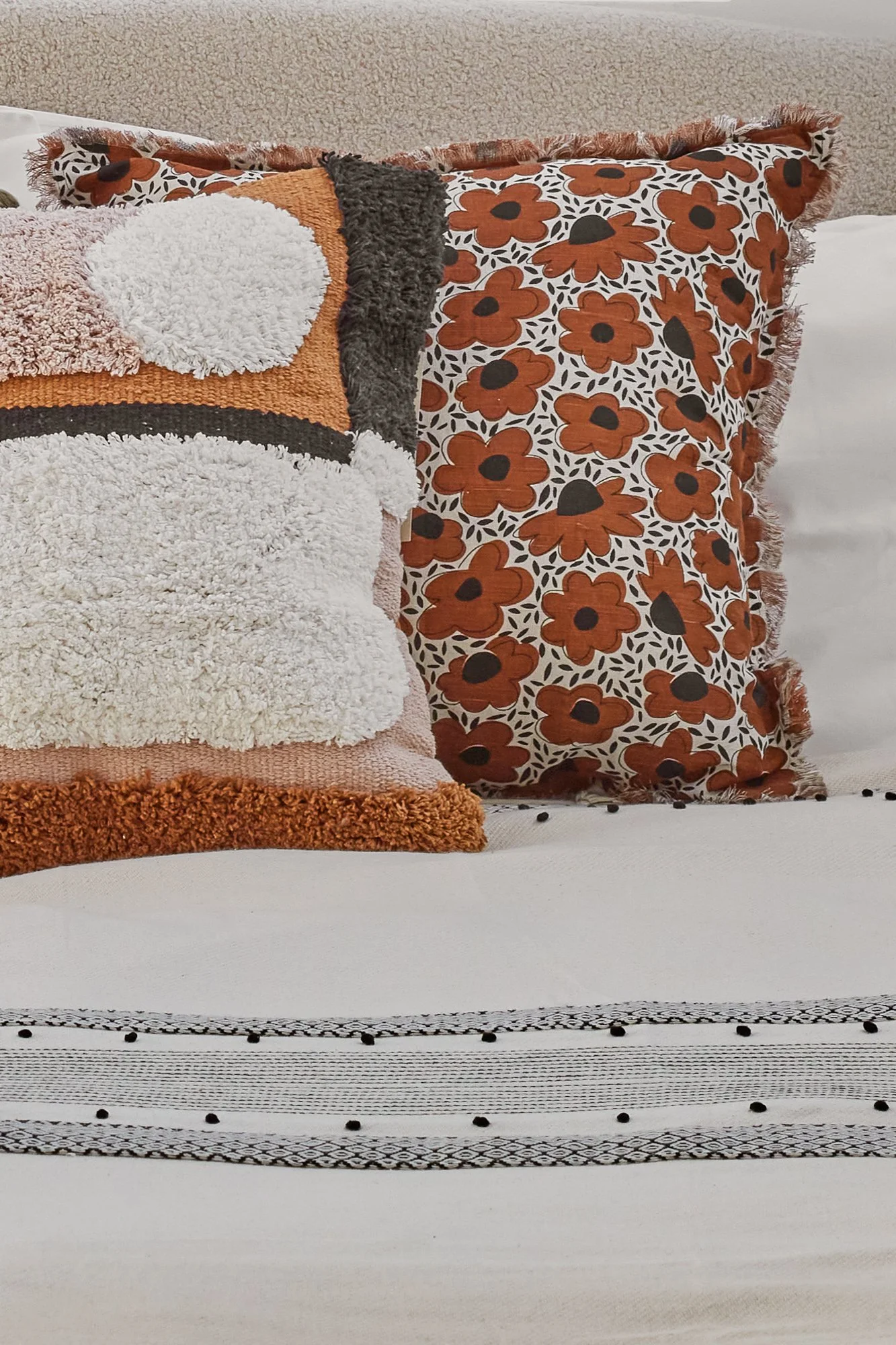 Decorative throw pillows in Wimbledon living room with floral and textured designs.
