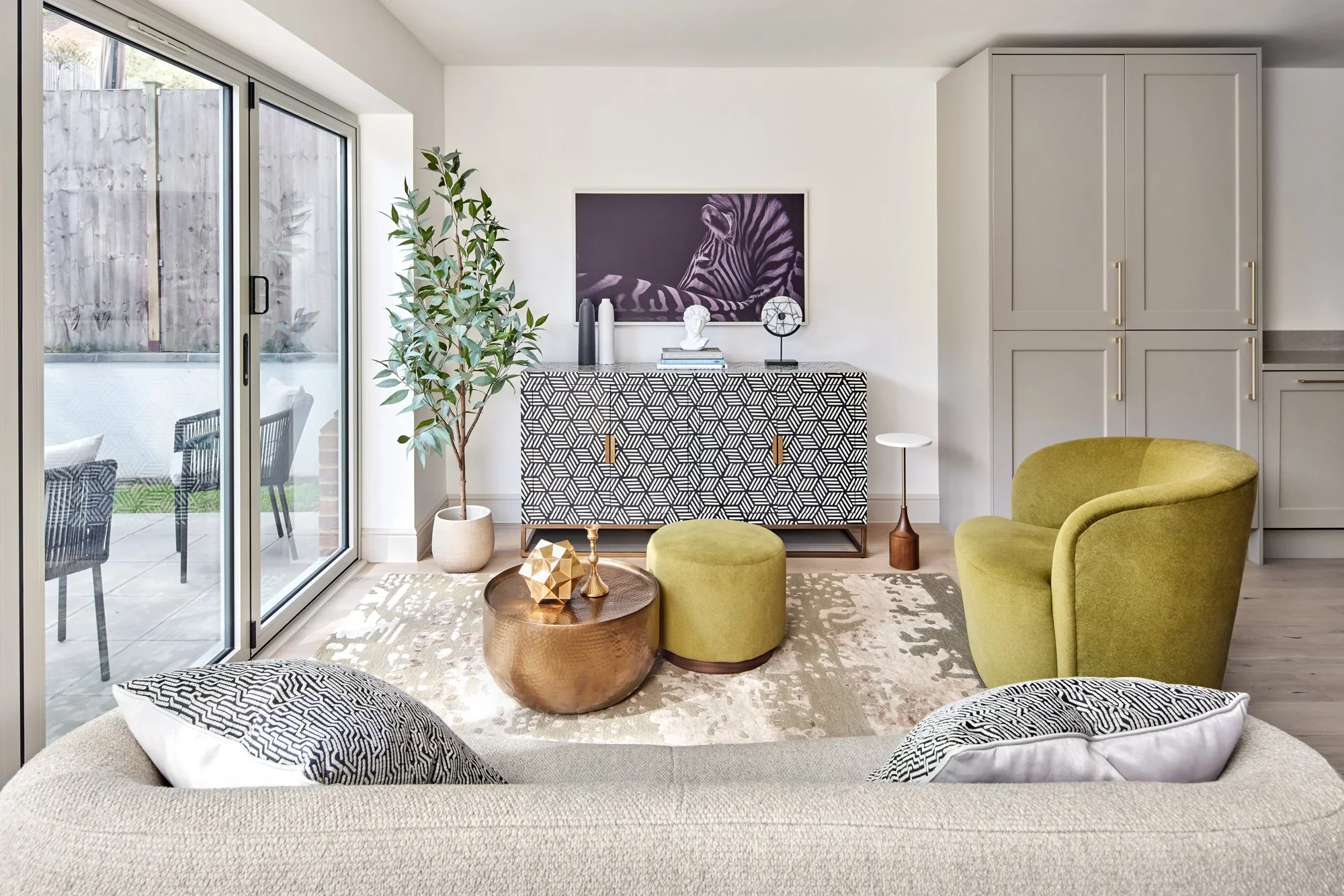 Wimbledon contemporary family room with curved sofa, Samsung Frame TV, and decorative accents.