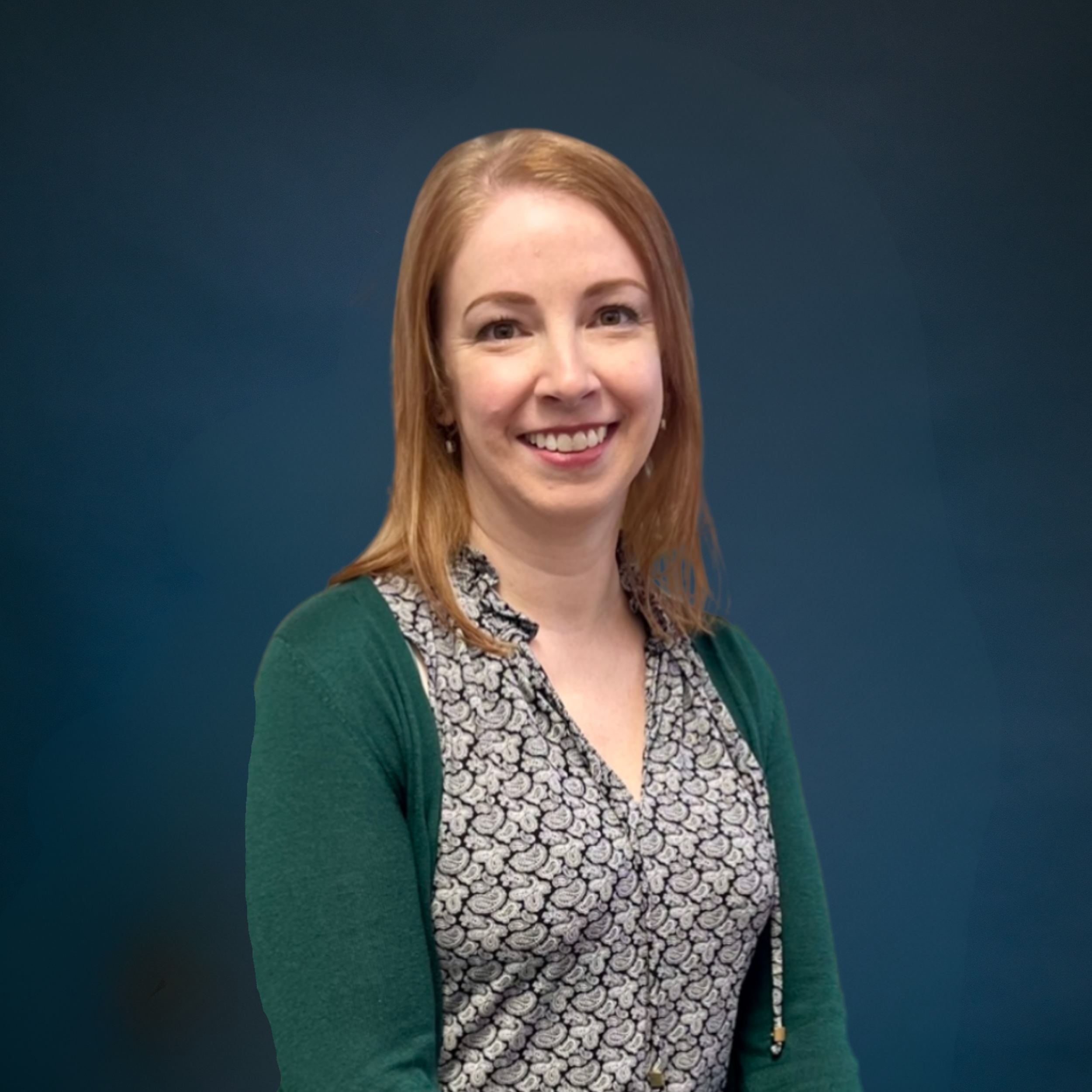 Person sitting on a beige leather chair in a modern, well-lit room with a picture on the wall.