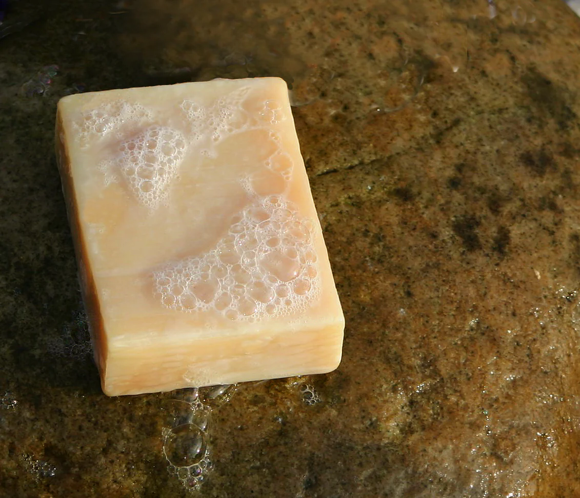 A bar of handmade soap covered in suds
