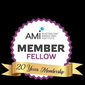 A badge with a purple and white scalloped border, text that reads 'AMM Australian Marketing Institute Member Fellow,' and a gold ribbon banner at the bottom stating '20 Years Membership.'