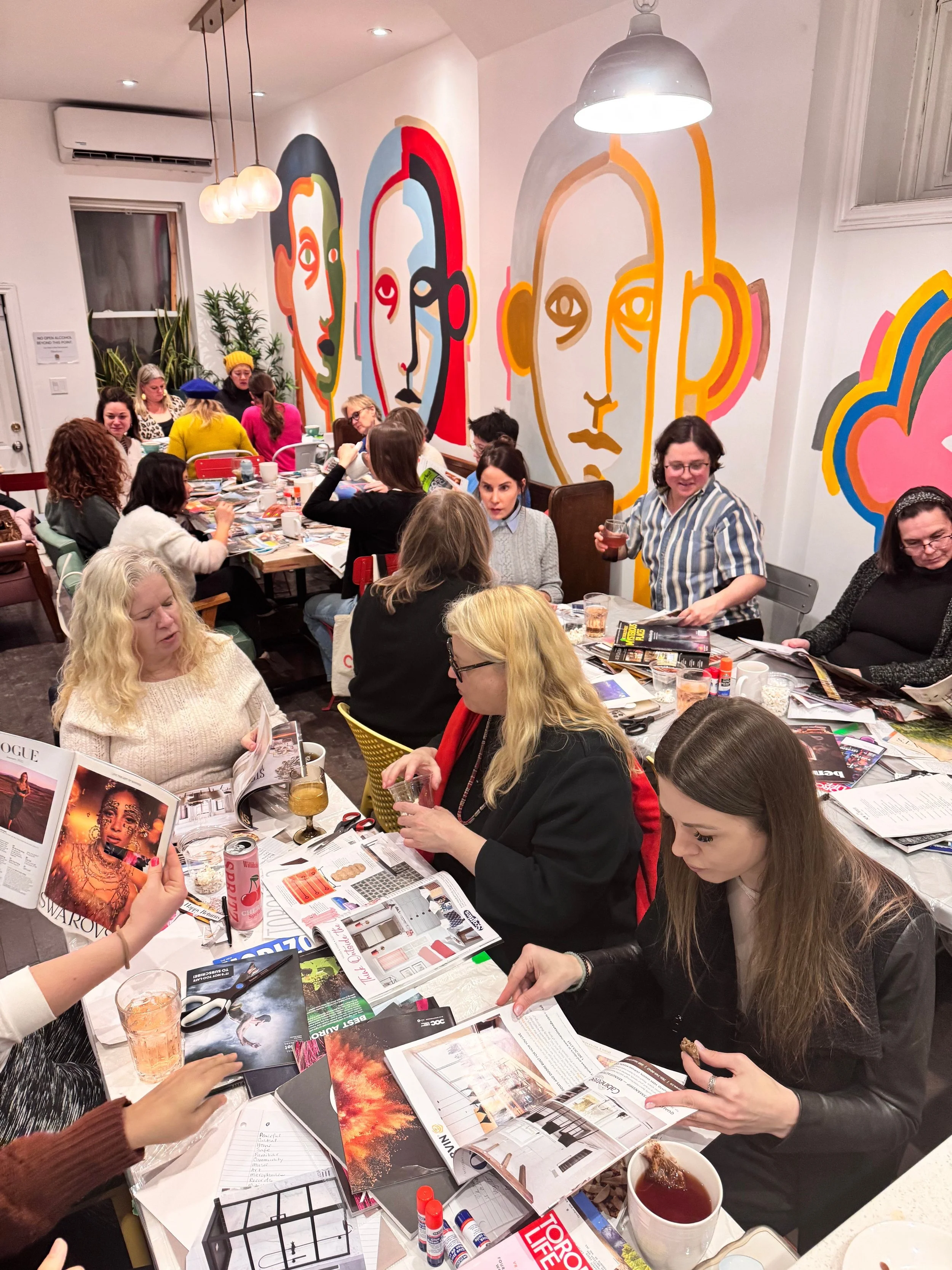 A group of people creating collages at an event hosted at Morning Parade's Upper Beaches cafe.