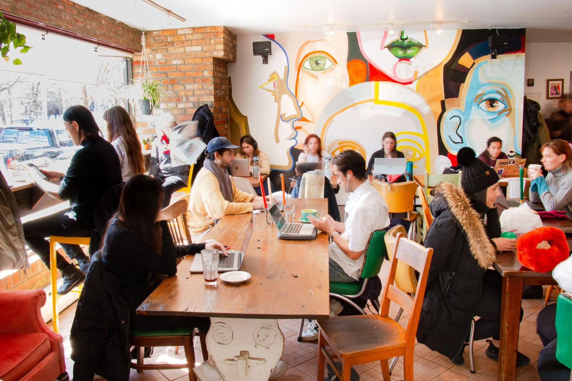 People working at laptops in the Morning Parade Coffee Bar Trinity Bellwoods cafe location.
