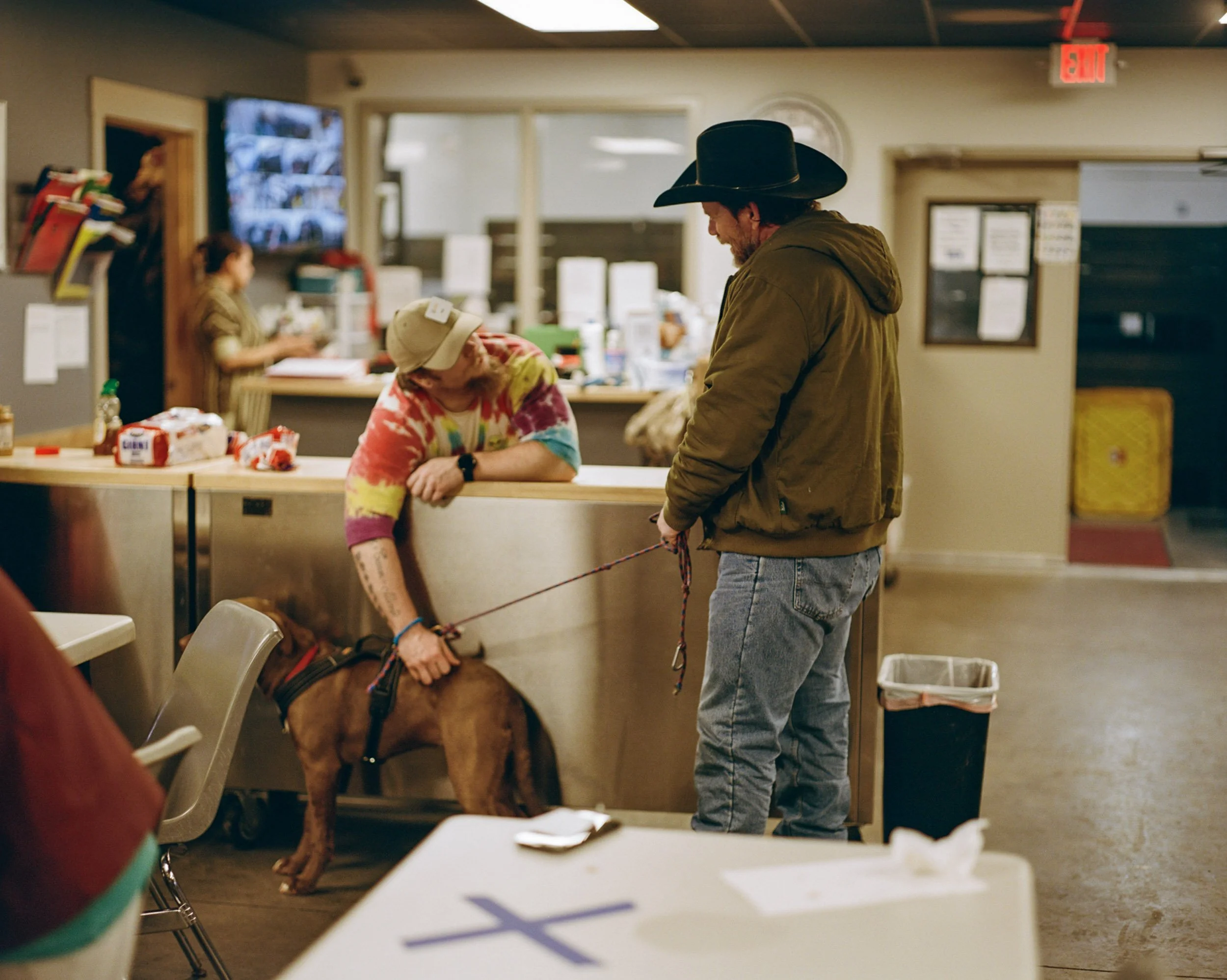 William Brown and his dog "Princess" talk with a volunteer at the warming center.