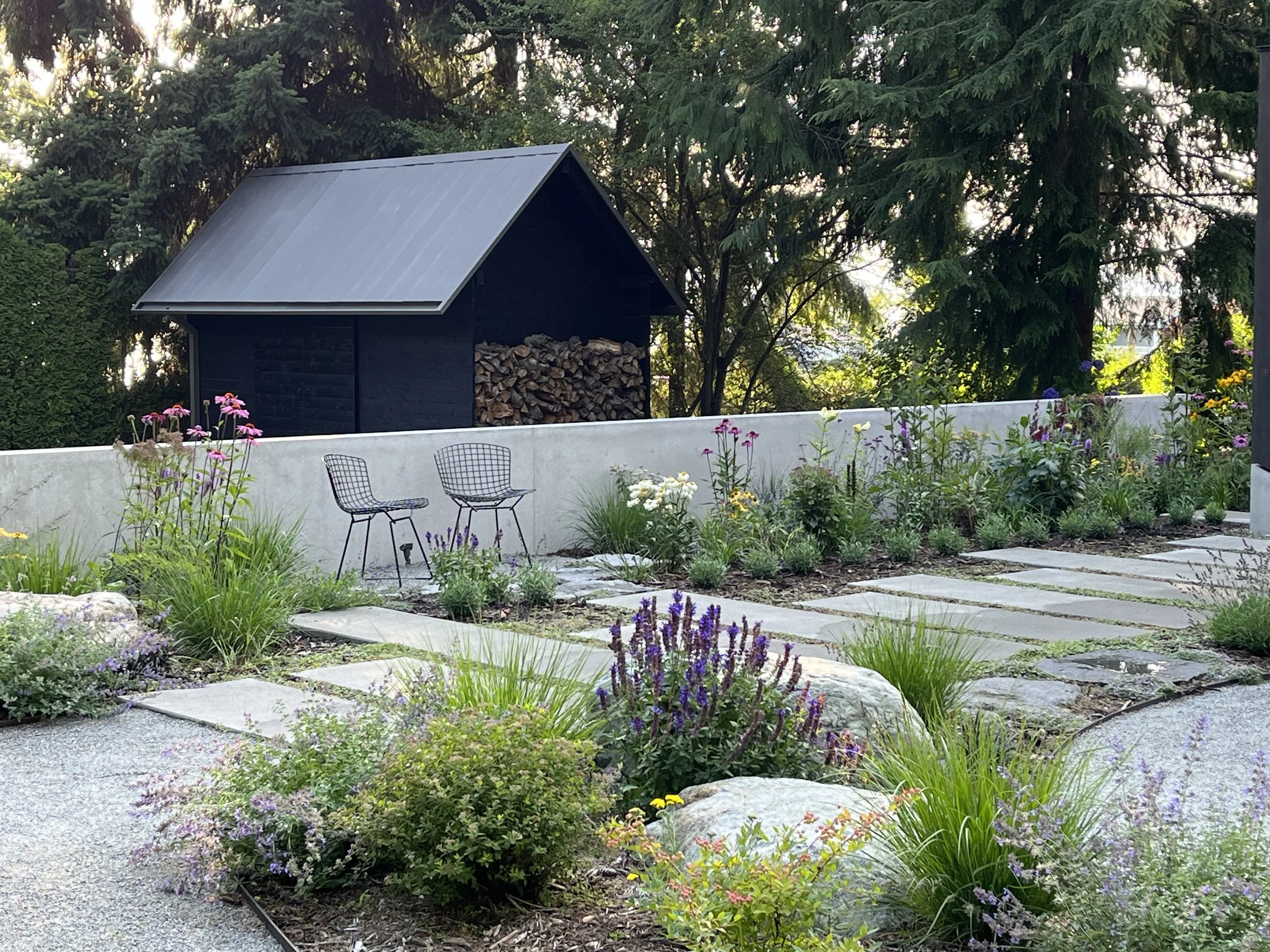 Black shed, wall, and perennial garden — Loyal Heights
